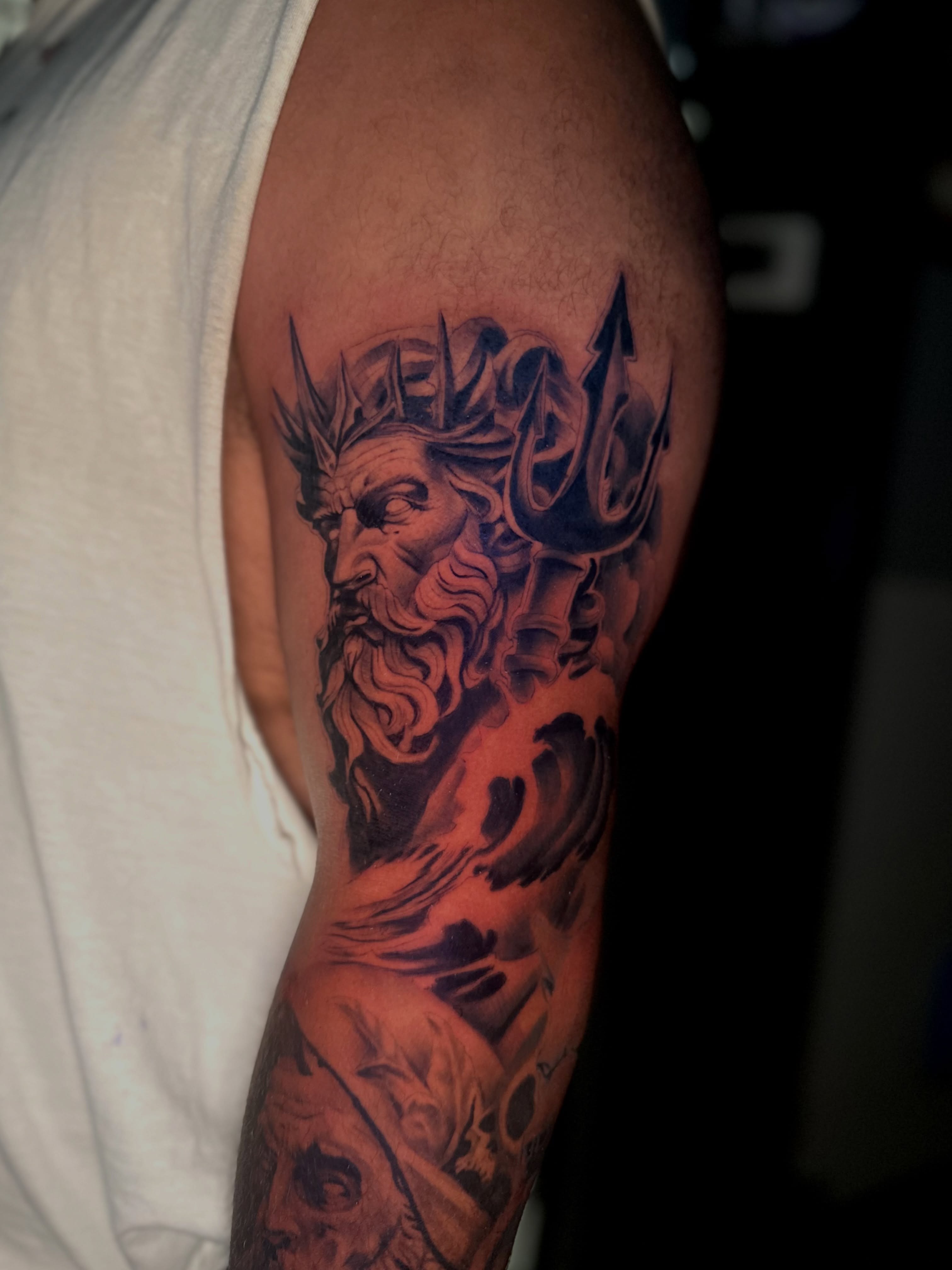 Poseidon realism tattoo on the forearm by Robert Douglas