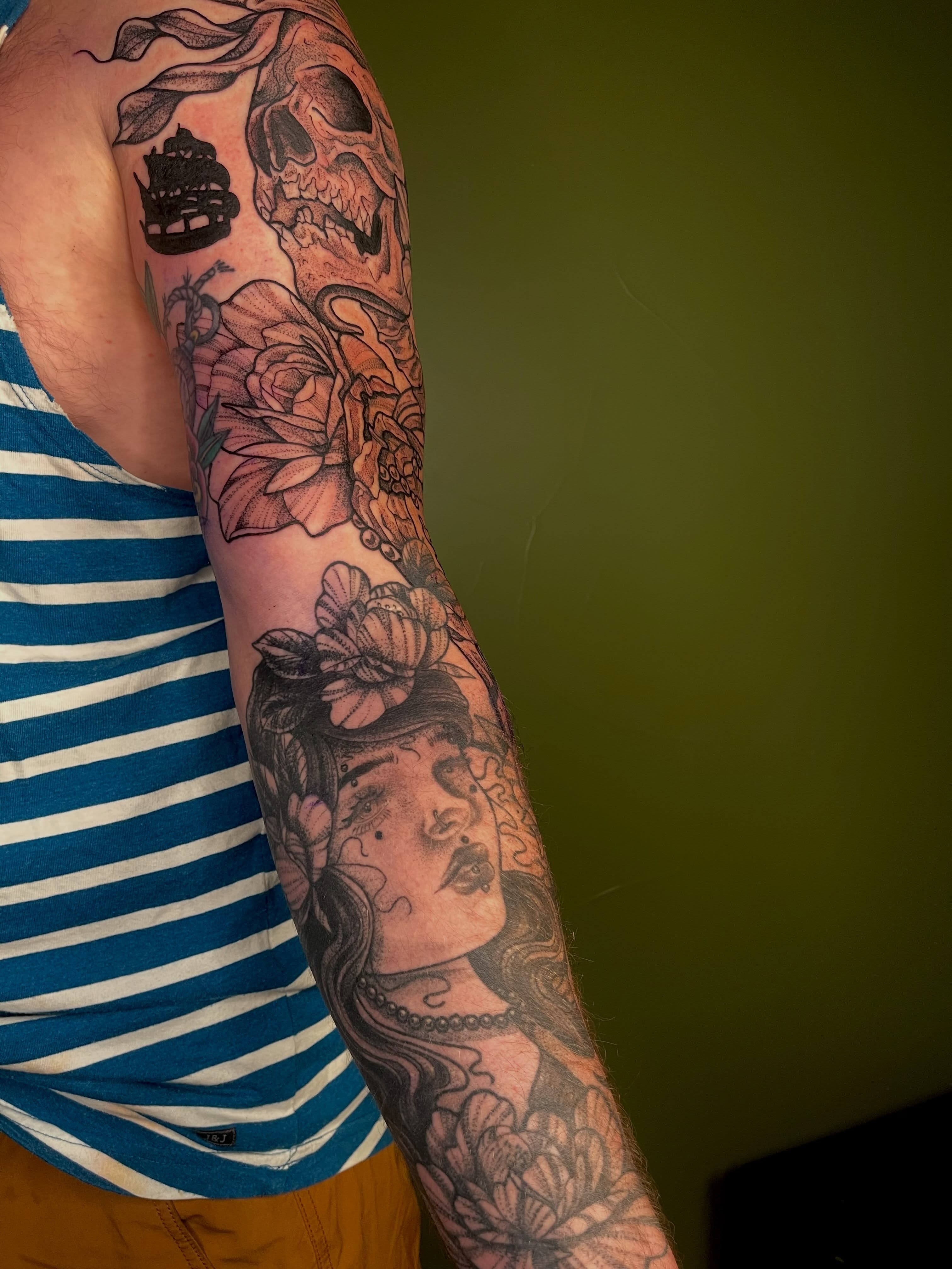 Woman with flowers American traditional tattoo on the forearm by Destiny Tolman