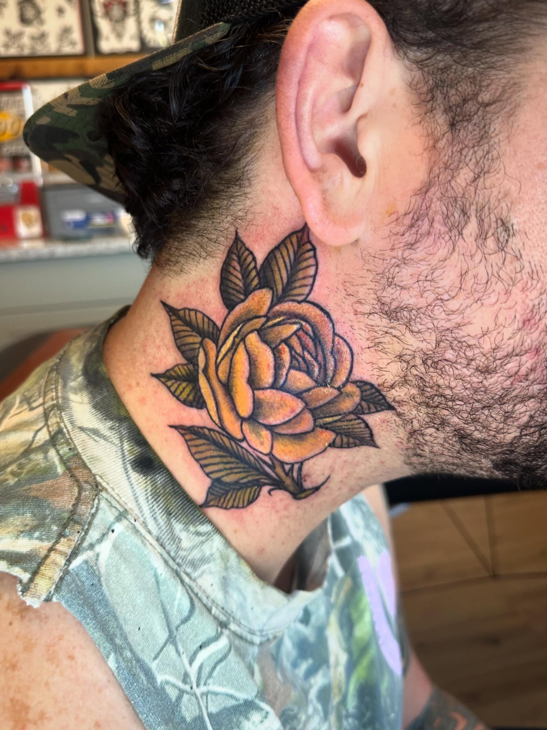 Rose American traditional tattoo on the neck by Kaylee Woods