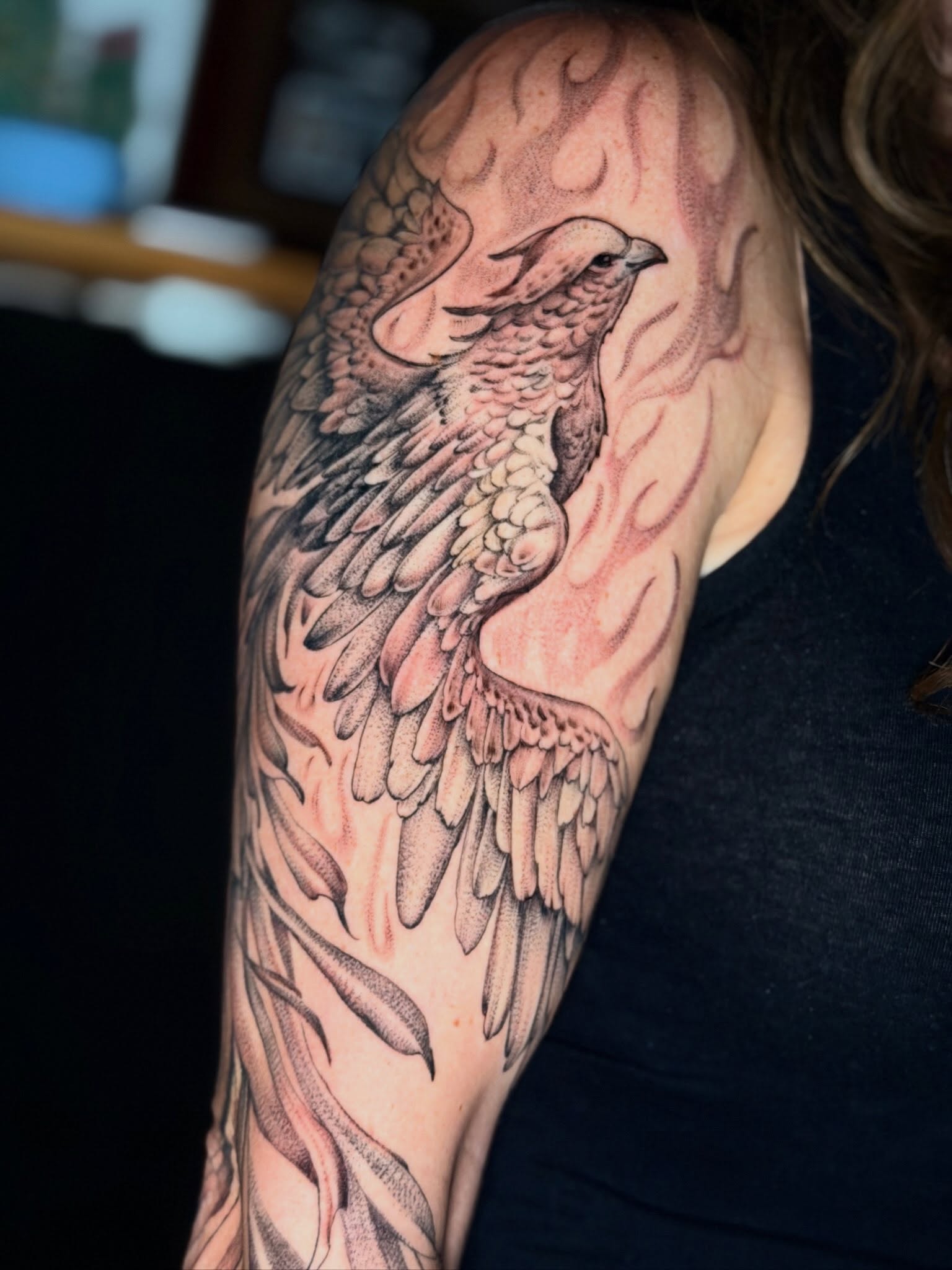 Bird dotwork tattoo on the upper arm by Giovanna Kline