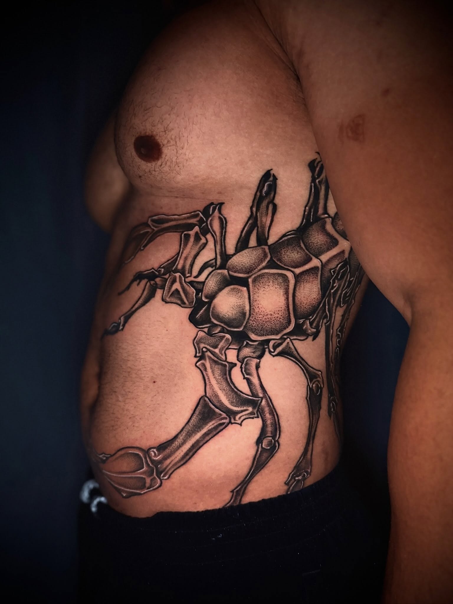 Spider geometric tattoo on the chest by Giovanna Kline