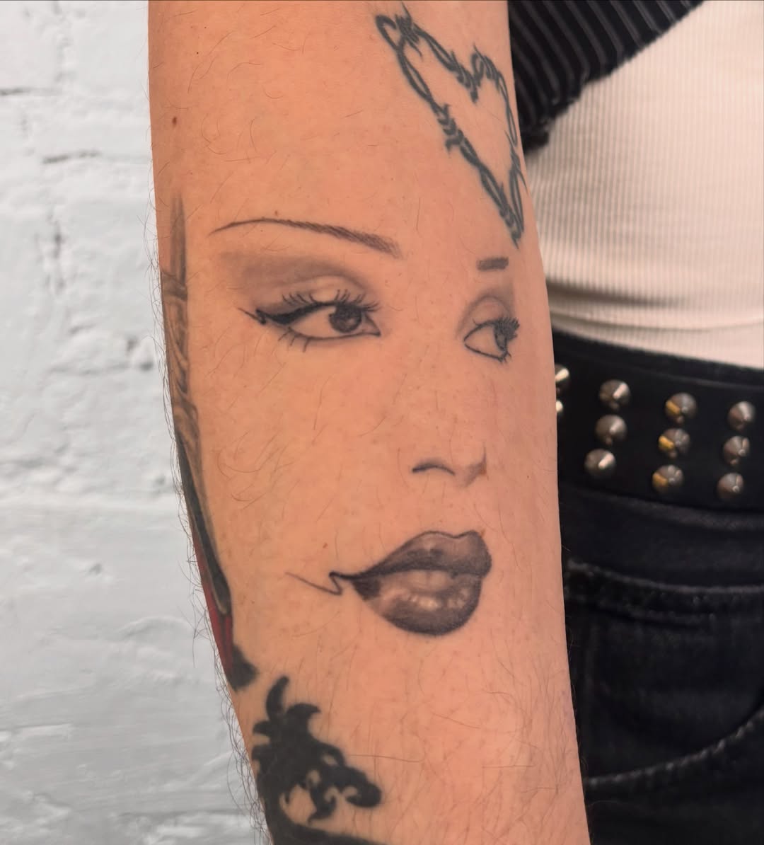 Woman's face realism tattoo on the forearm by laura bianca