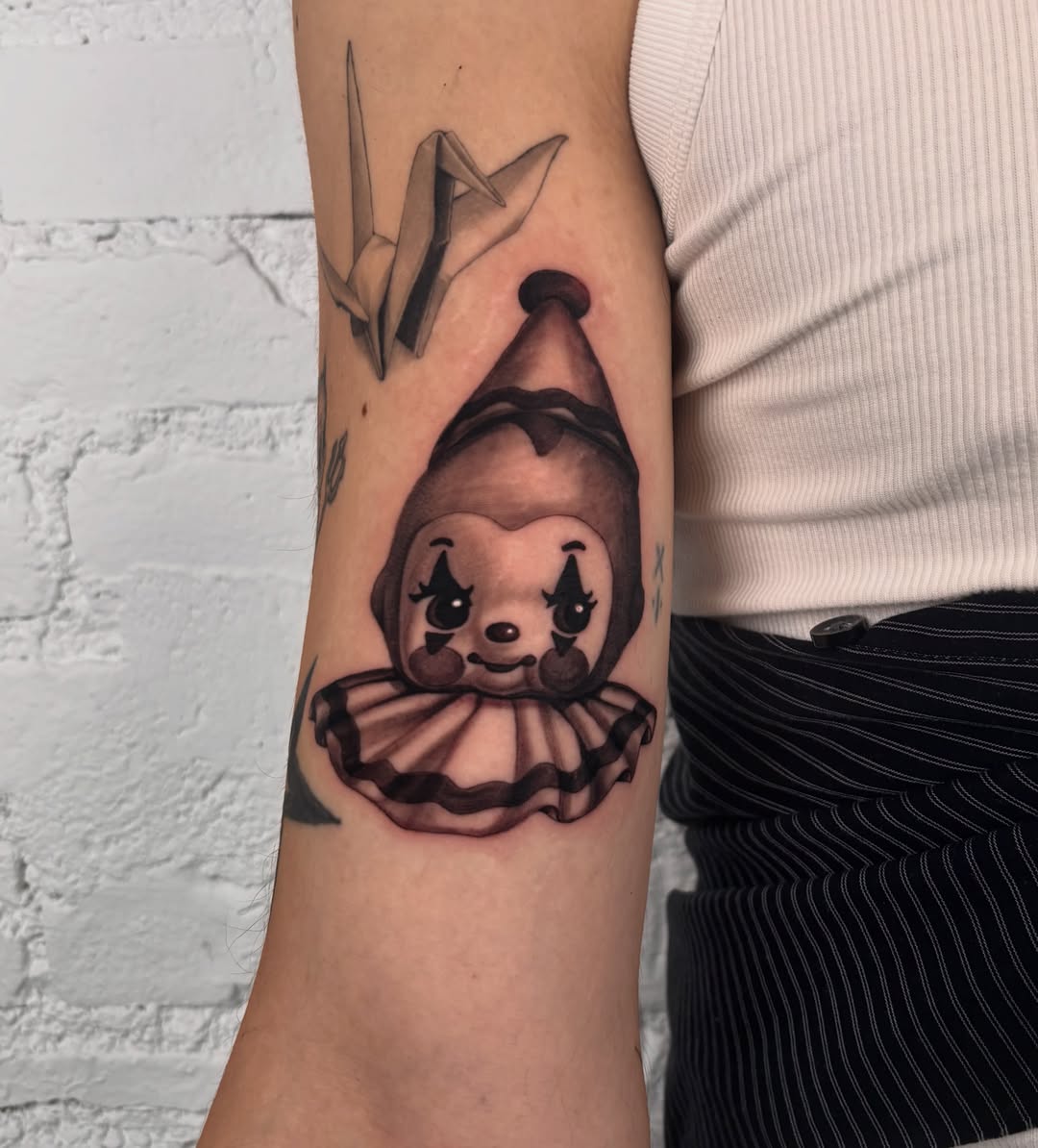 Clown bear black and grey tattoo on the forearm by laura bianca