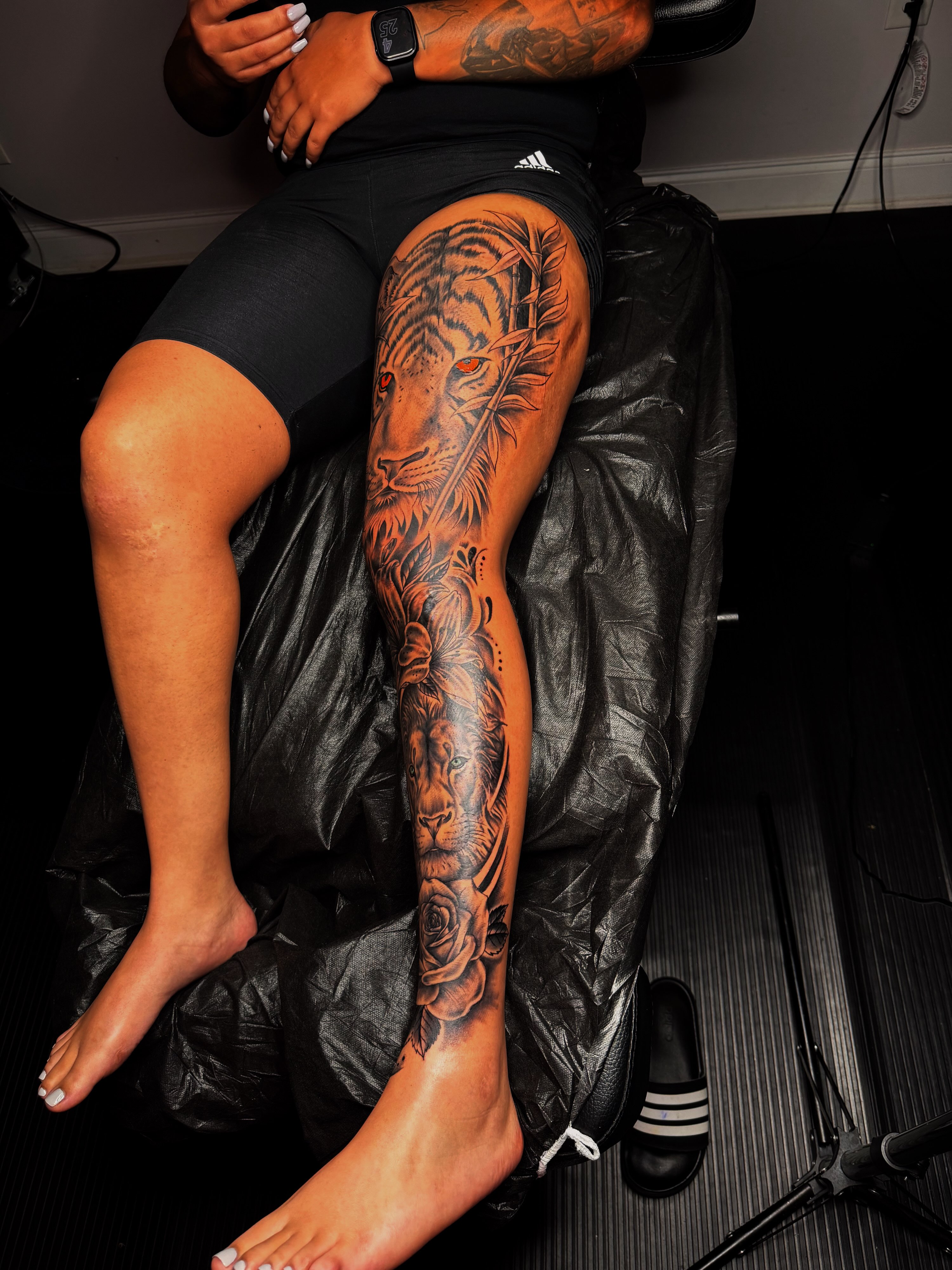 Lion and roses realism tattoo on the leg by Q⚜️