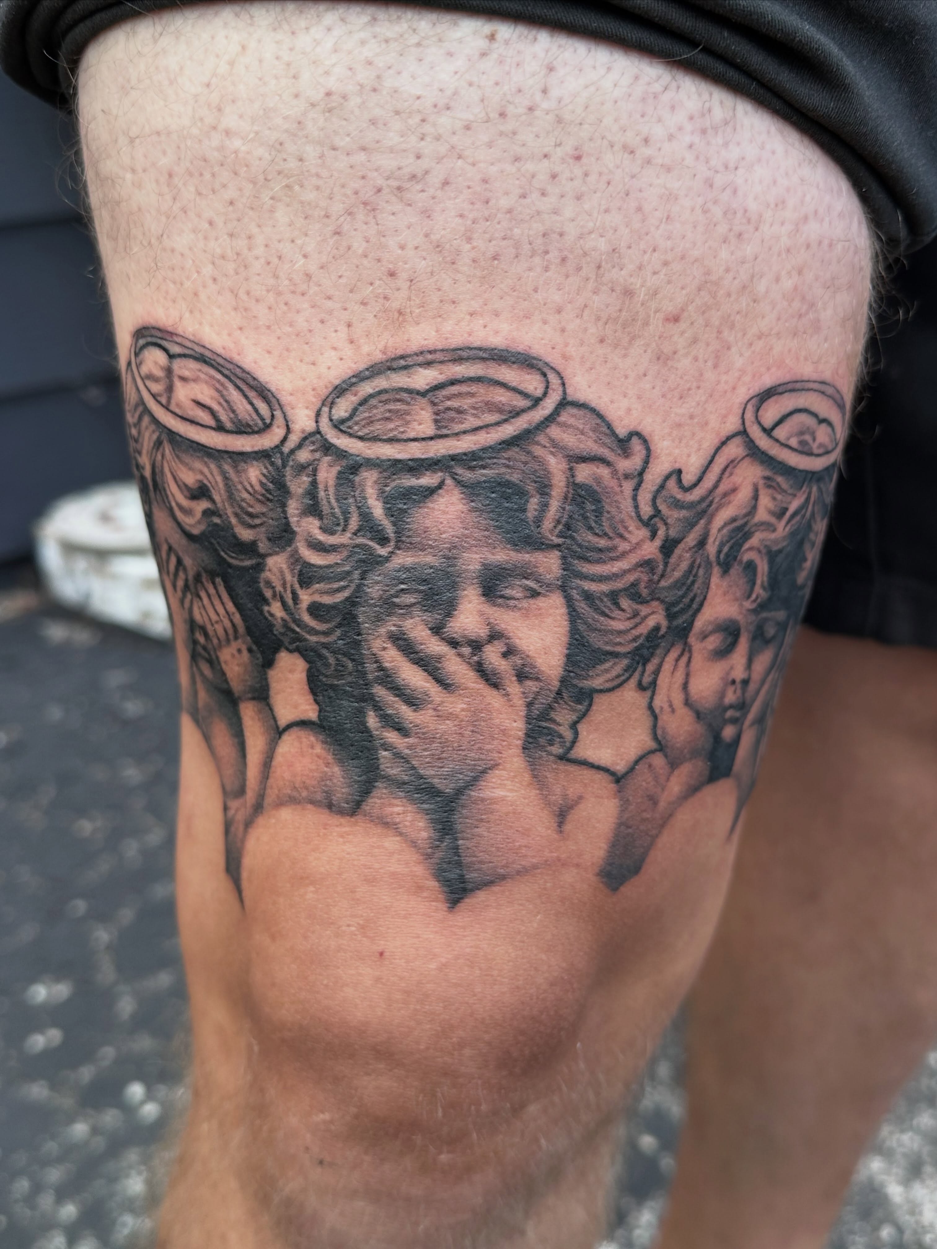 Angels black and grey tattoo on the thigh by Dustin Clark, Dayton, Ohio
