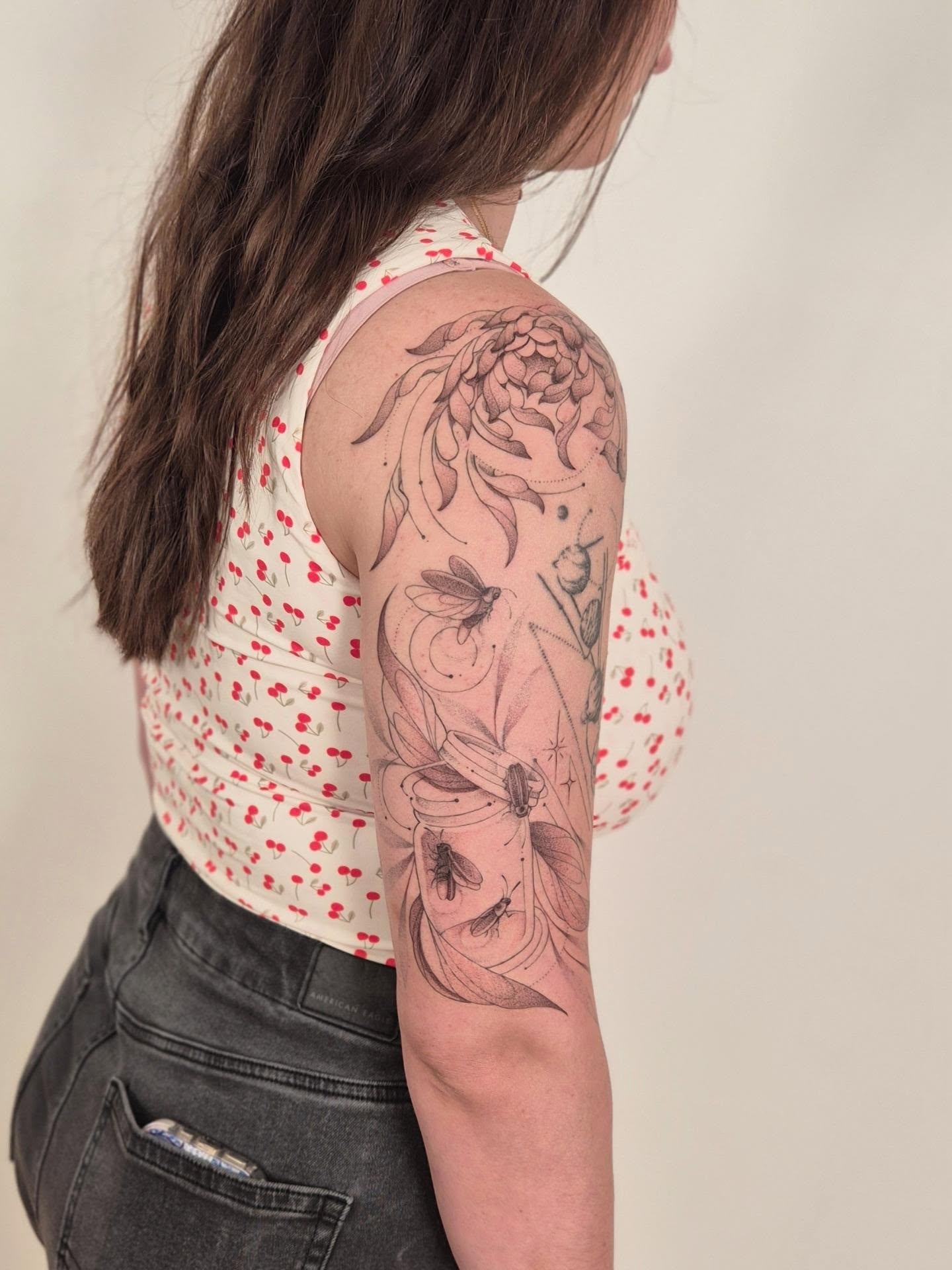Insects and flowers black and grey tattoo on the upper arm by Sophorn Long (soapy)
