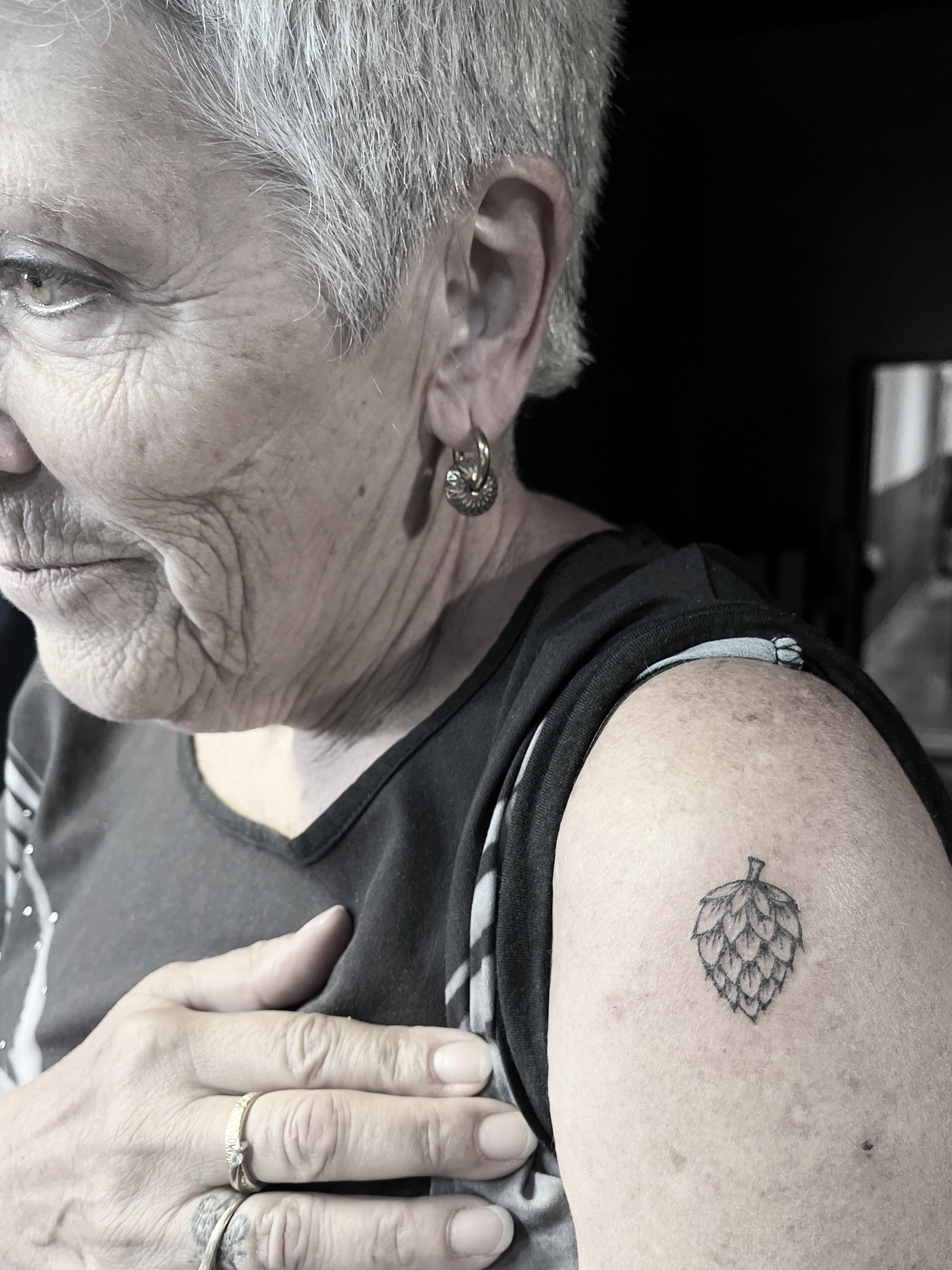 Hop cone black and grey tattoo on the shoulder by La Main Bleue