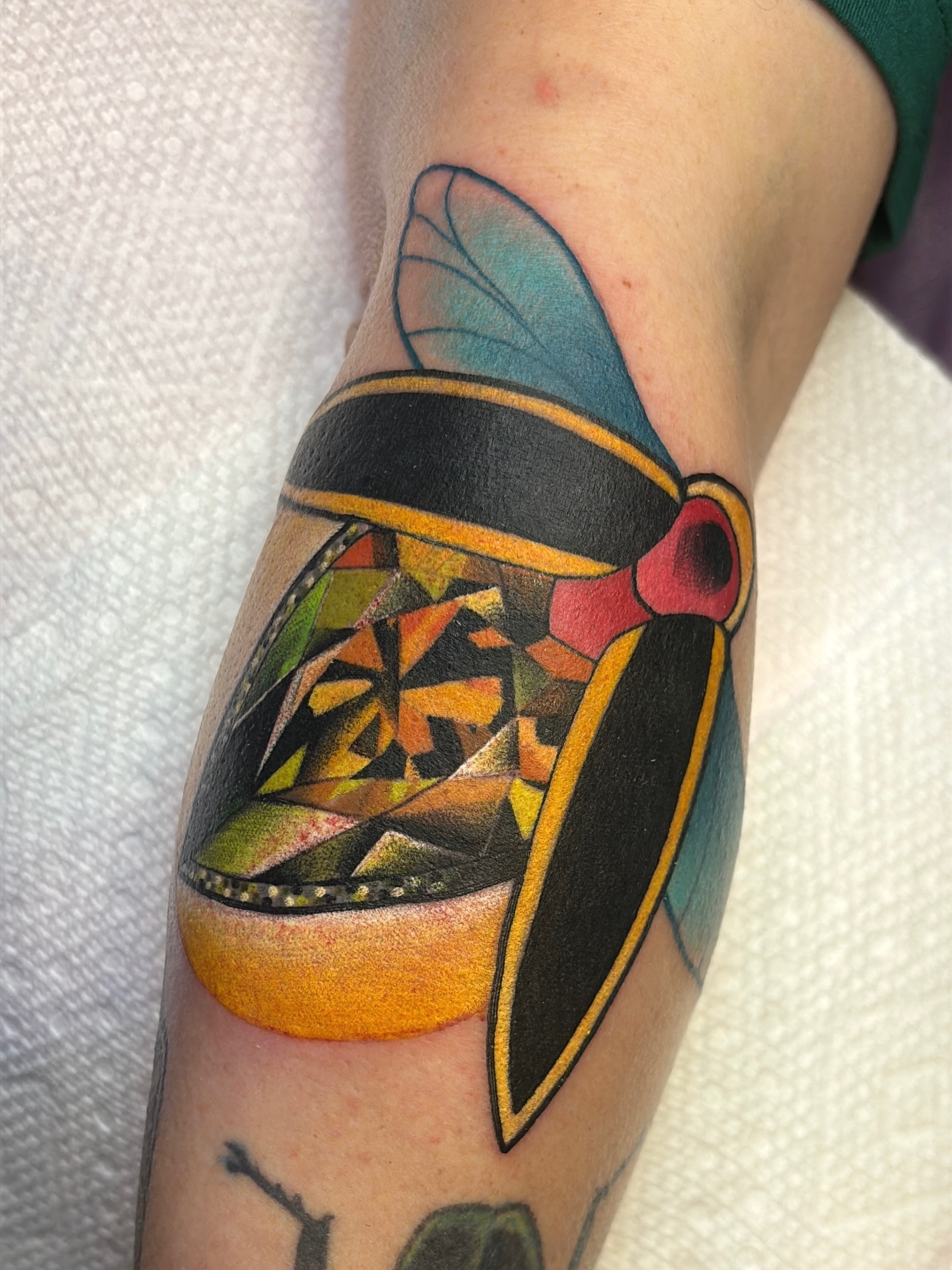 Geometric mask geometric tattoo on the forearm by Latesha Burnley