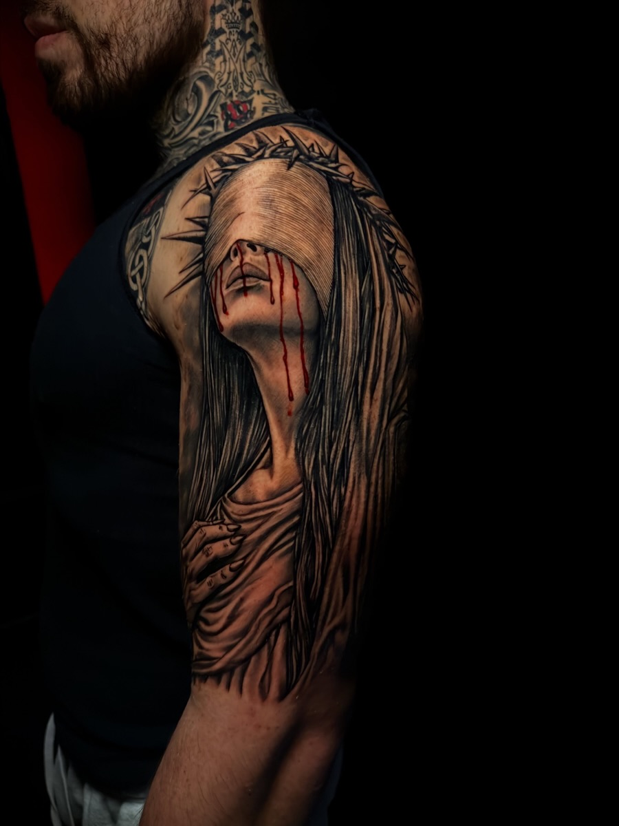 Jesus Christ realism tattoo on the upper arm by Alex