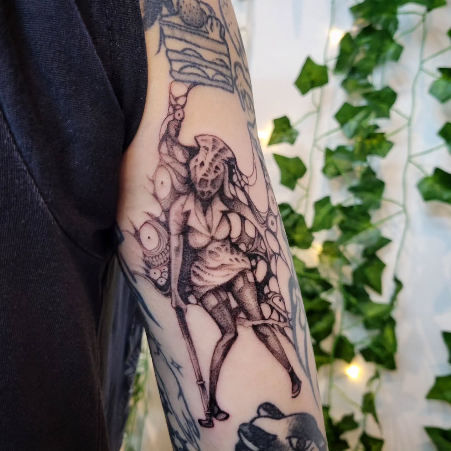 Demon-like creature dark realism tattoo on the forearm by Uku Tattoos, Cambridge, England