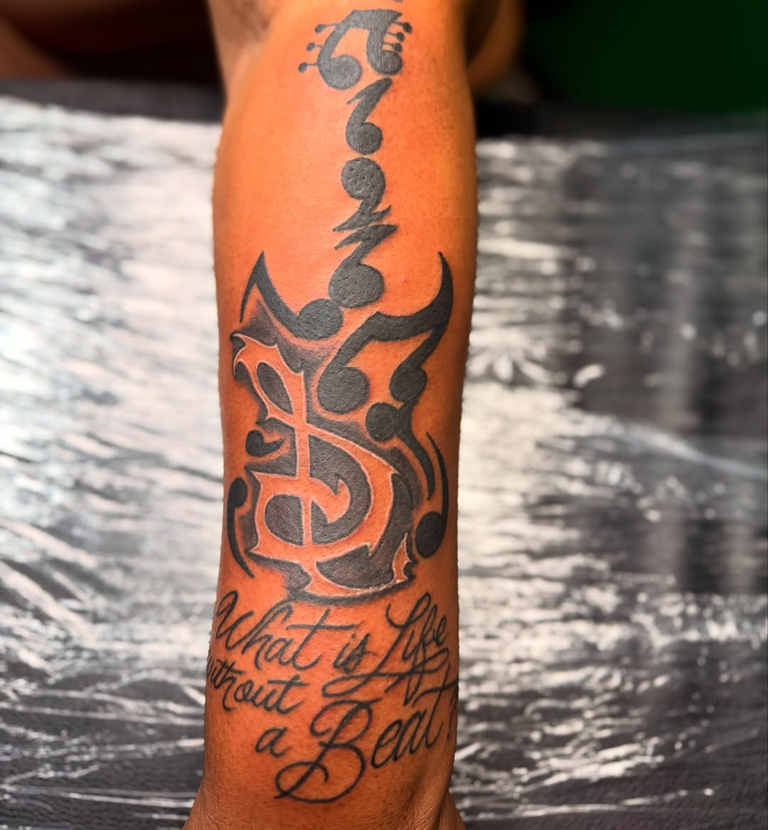Tattoo by @ink_by_tyga — tribal, lettering_script