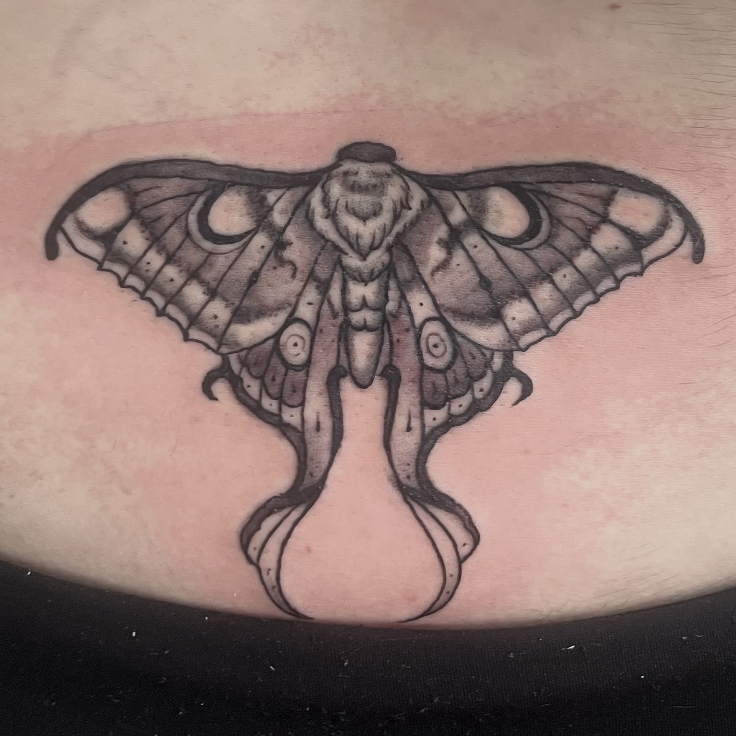 Moth black and grey tattoo on the thigh by Brianna Jo Ballinghoff