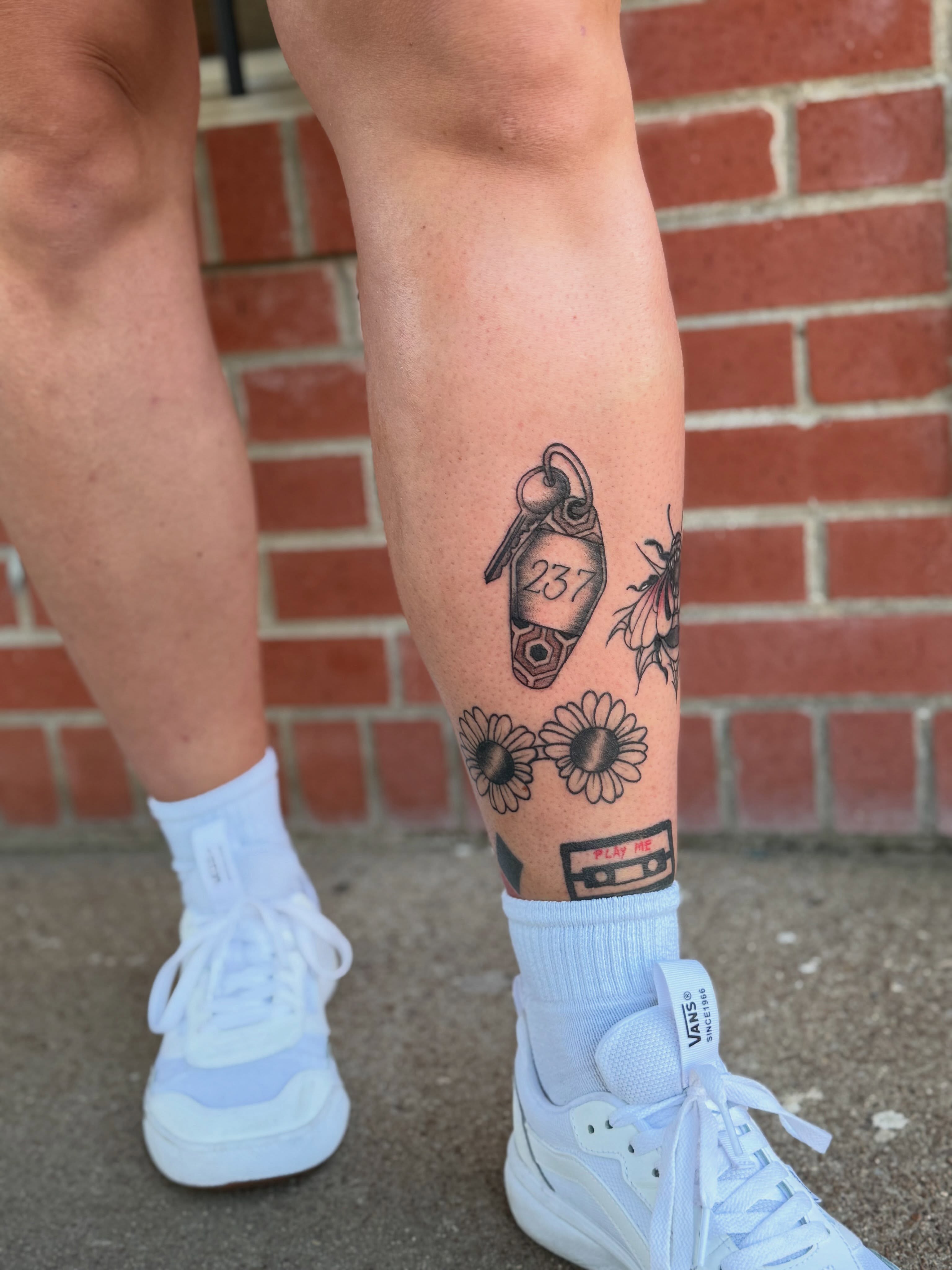 Keychain and flowers black and grey tattoo on the calf by Aly Rucker, Murfreesboro, Tennessee