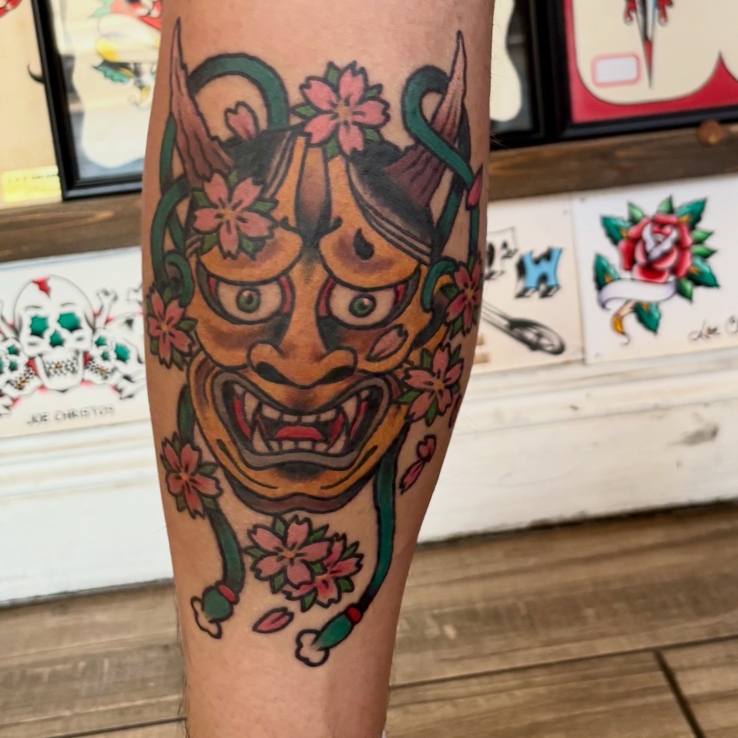 Demon mask with cherry blossoms American traditional tattoo on the forearm by Las Vegas Tattoo Artist