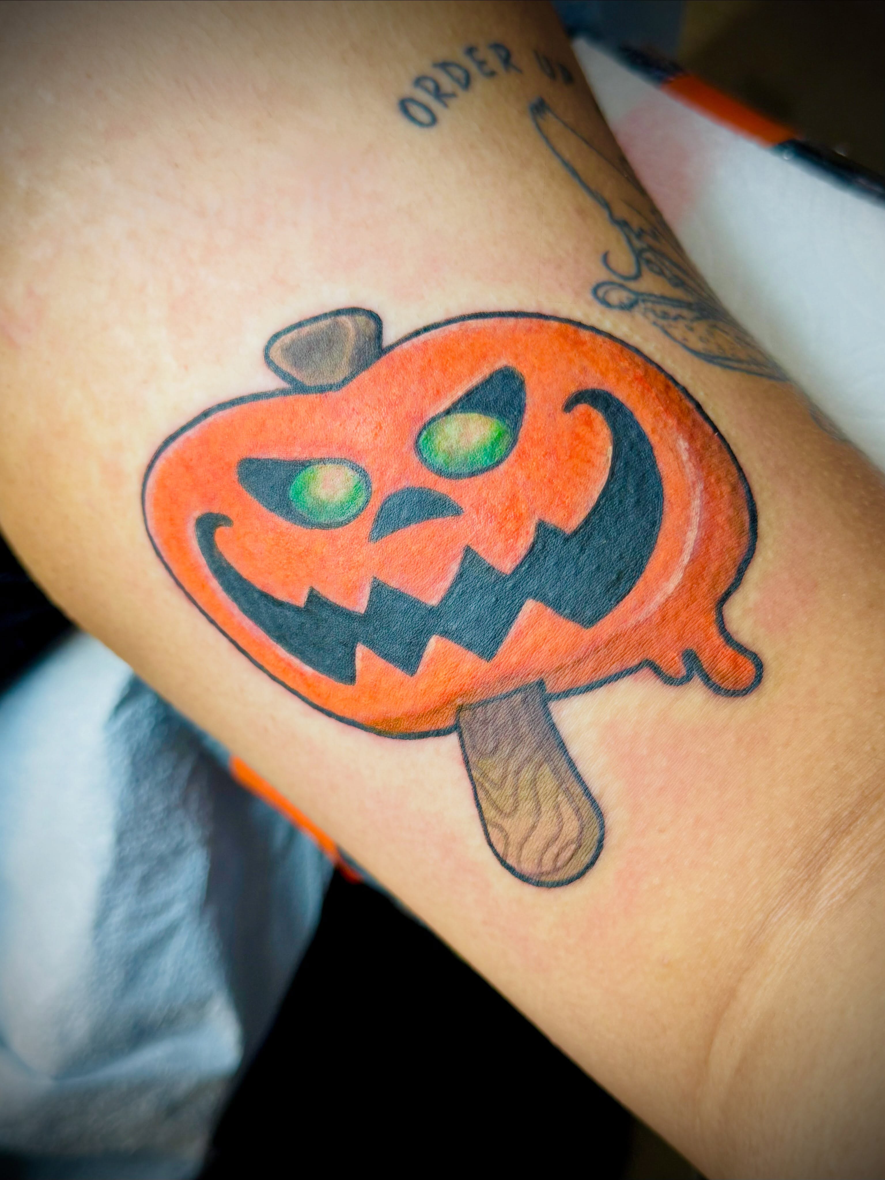 Jack-o'-lantern American traditional tattoo on the forearm by San Diego Tattoo Artist