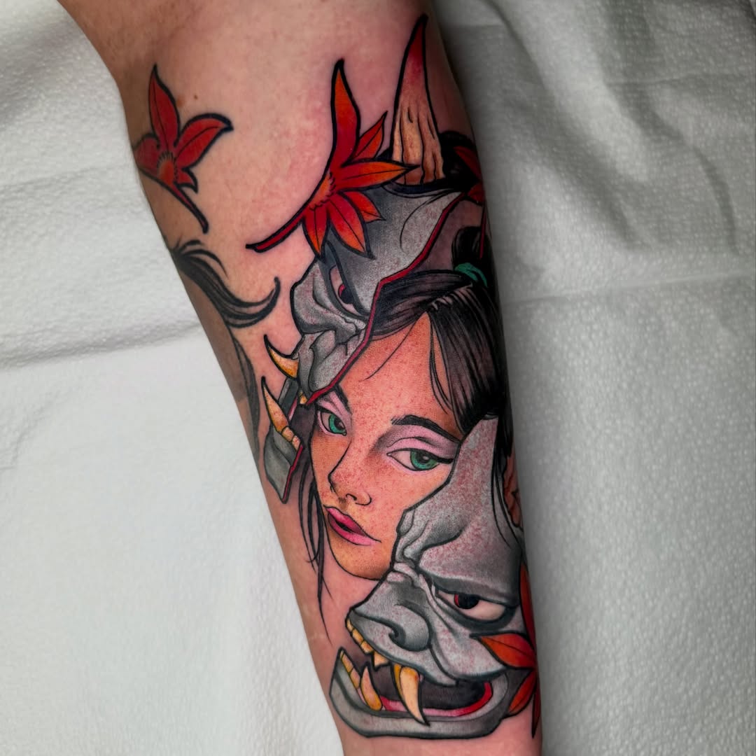 Woman with mask American traditional tattoo on the forearm by Aaron Borden