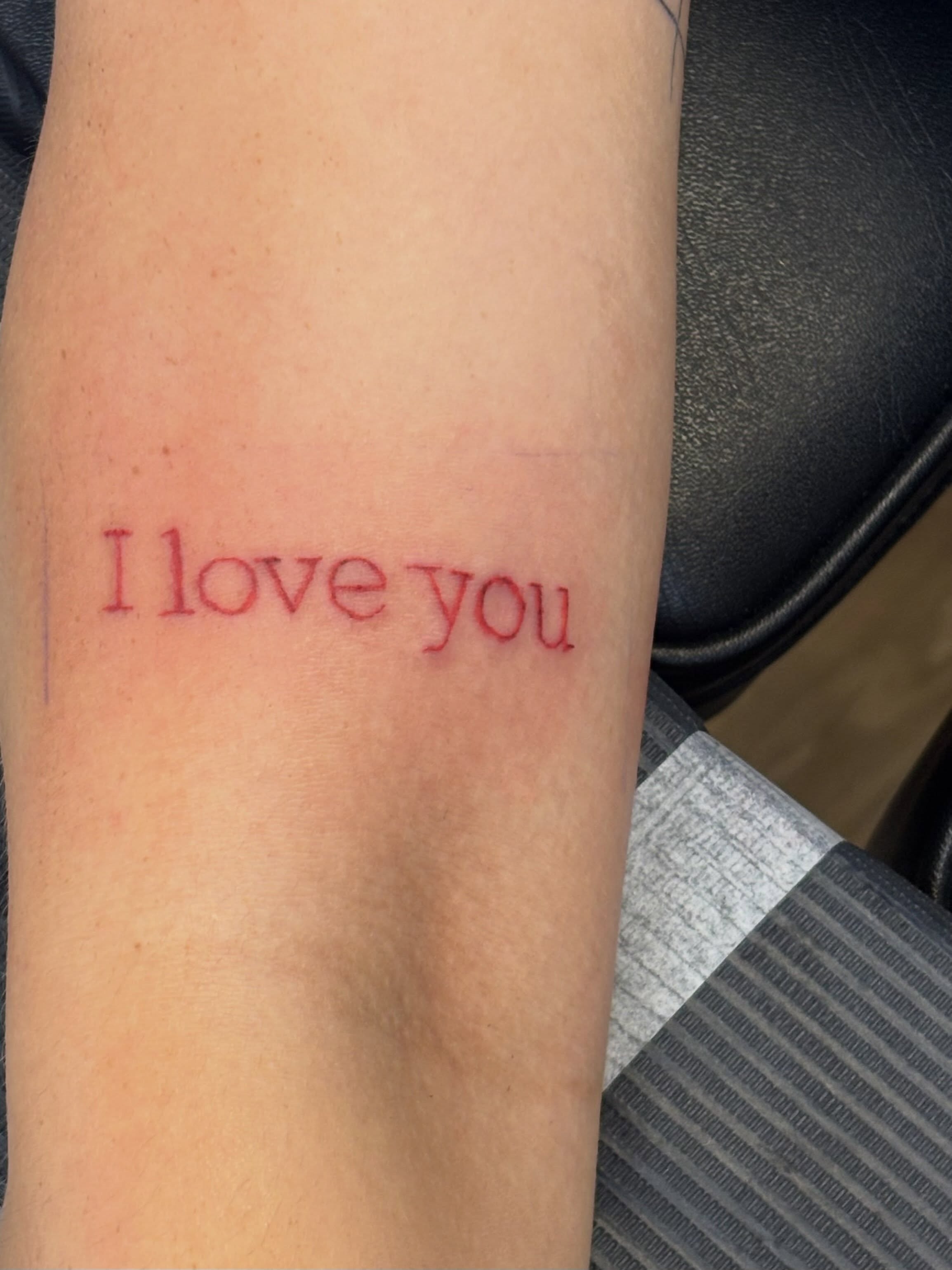 I love you lettering script tattoo on the forearm by Natalie Jade Shupe