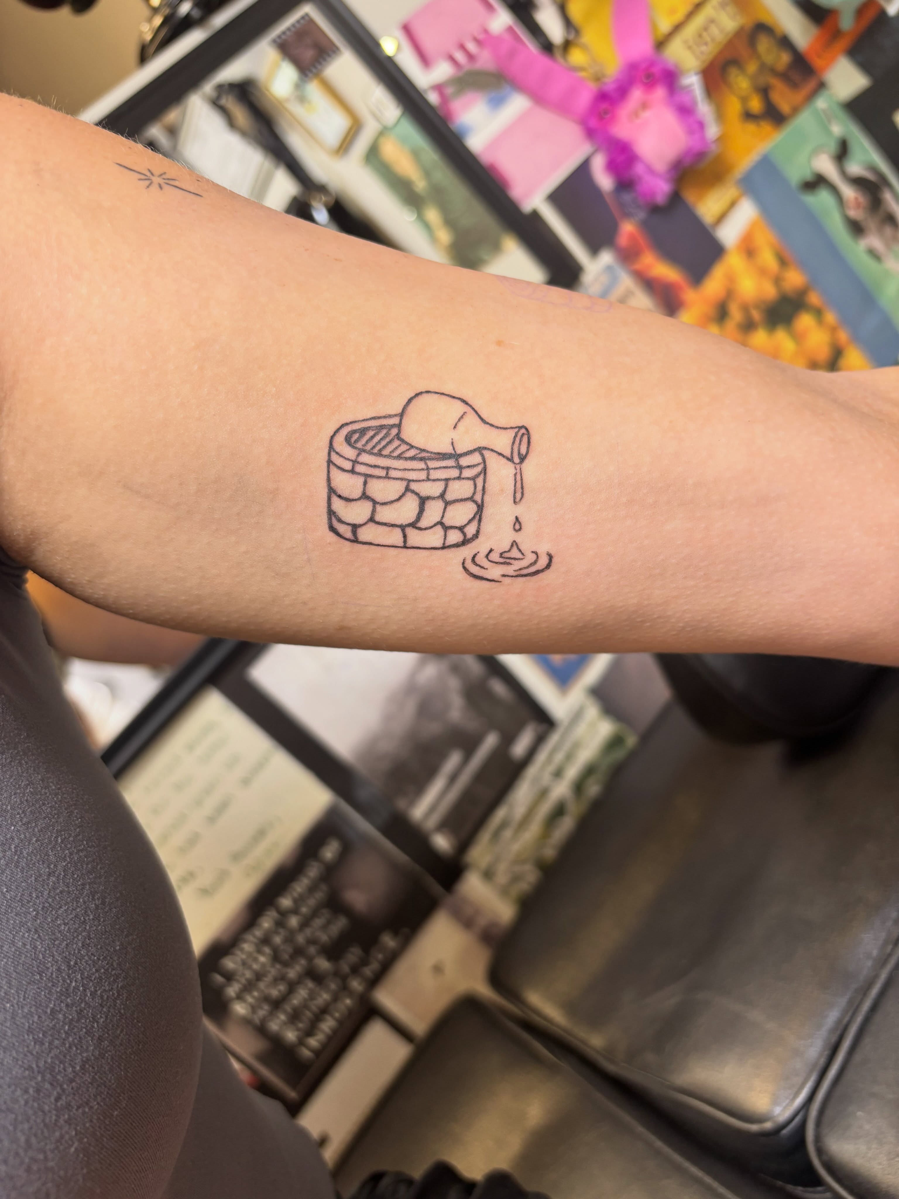 Stone well with flowing water black and grey tattoo on the forearm by Natalie Jade Shupe