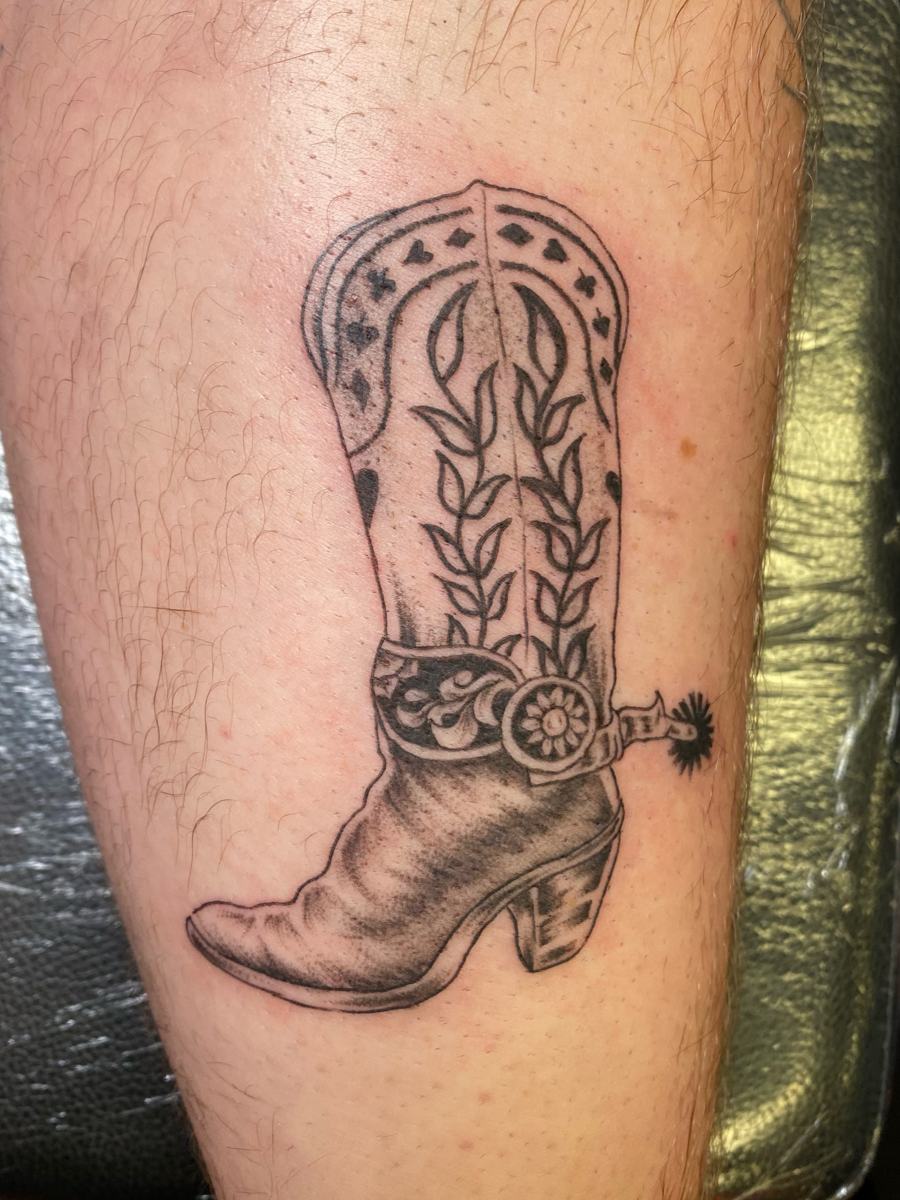 Cowboy boot black and grey tattoo on the thigh by Mack ๐ Utah Tattoos