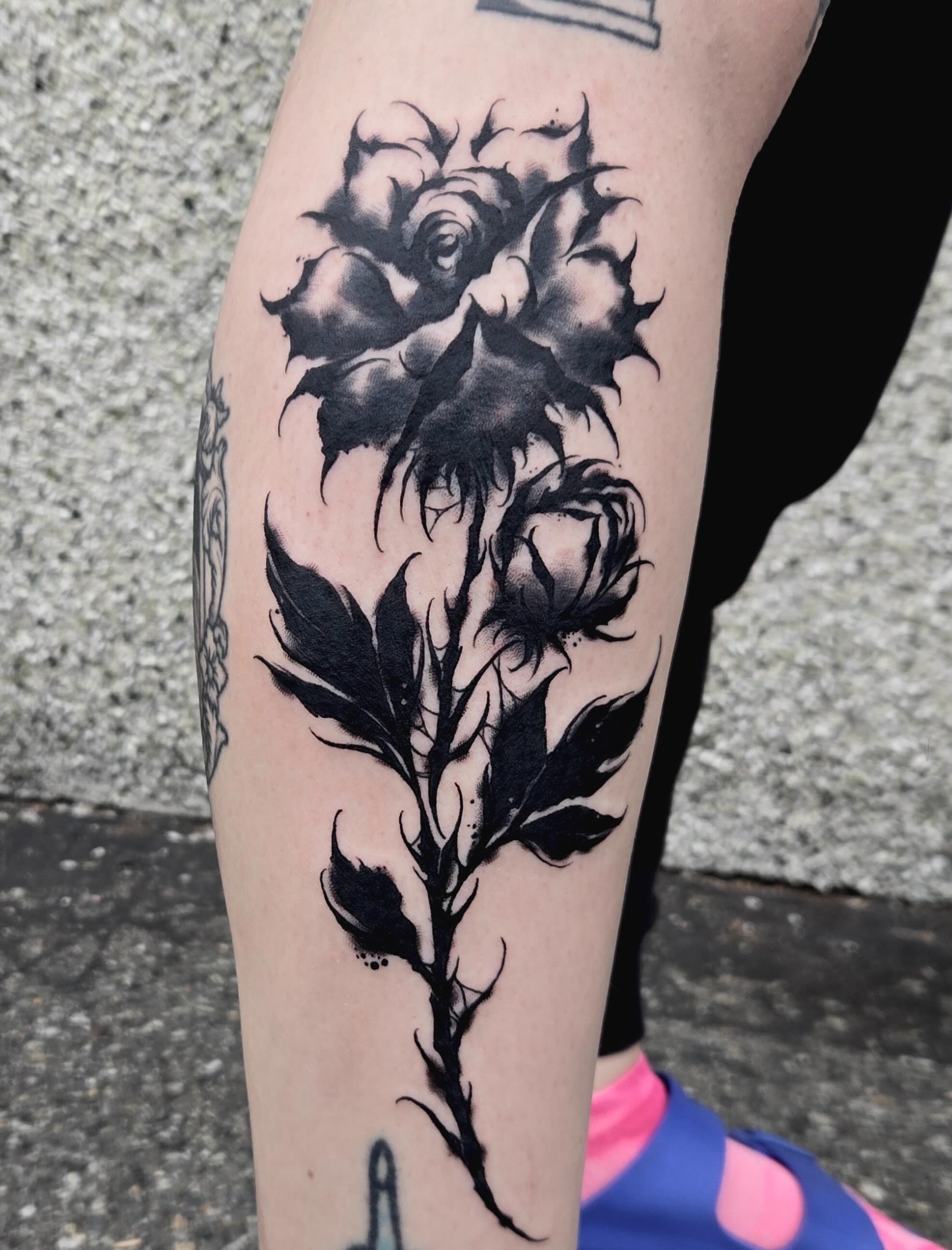 Rose black and grey tattoo on the forearm by ๐