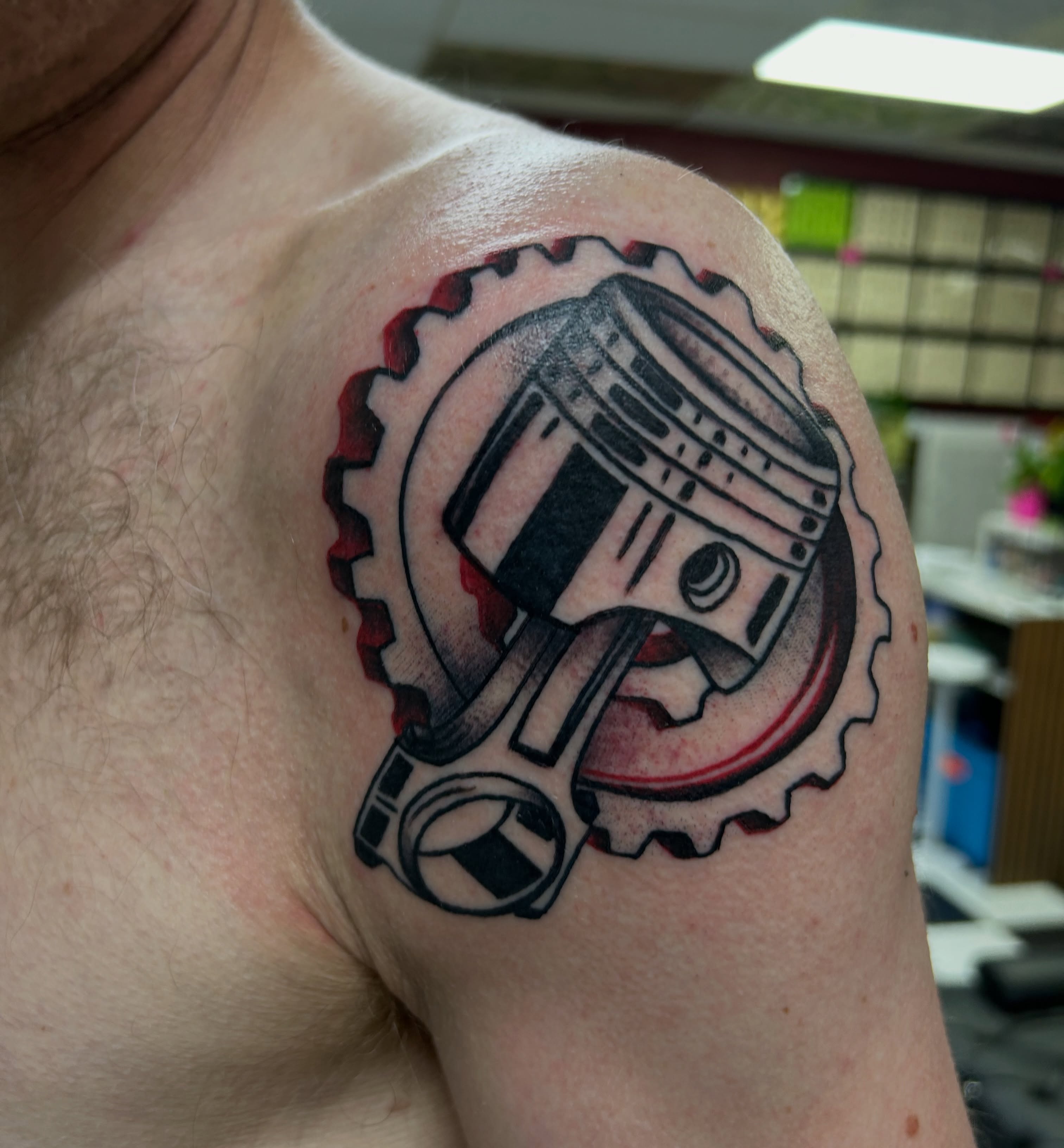 Piston and gear black and grey tattoo on the shoulder by Tattoos by Corey aka MrLu