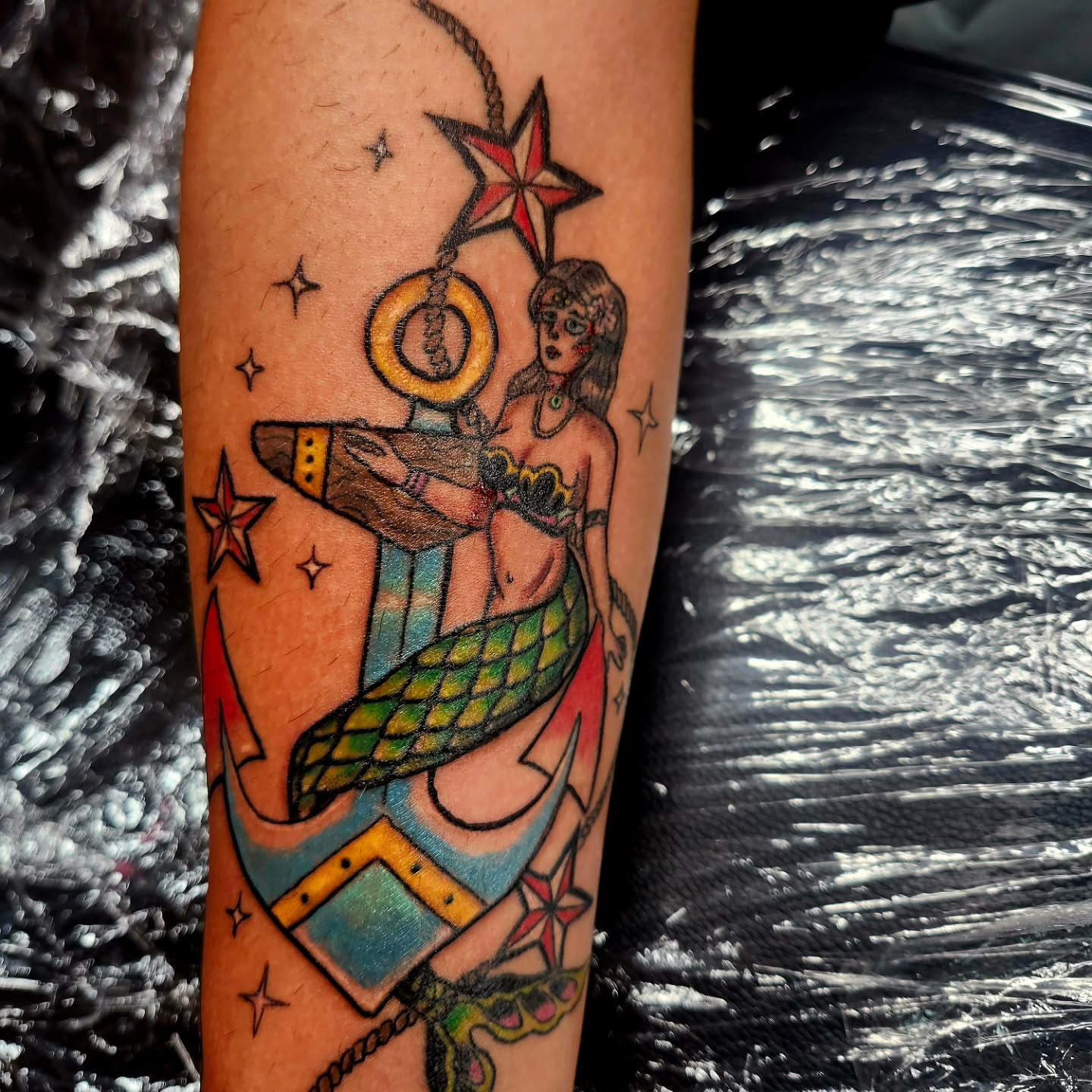 Mermaid and anchor American traditional tattoo on the forearm by @rockinr33d.tattoos