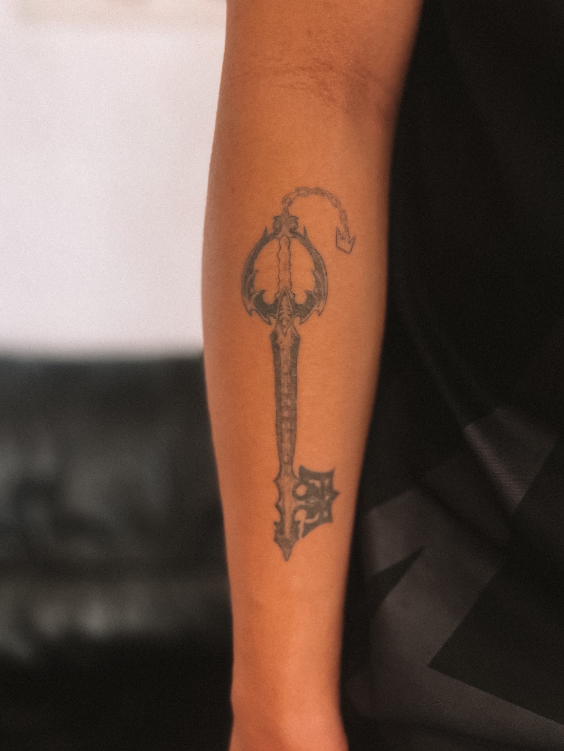 Key black and grey tattoo on the forearm by sebs phạm, Los Angeles, California