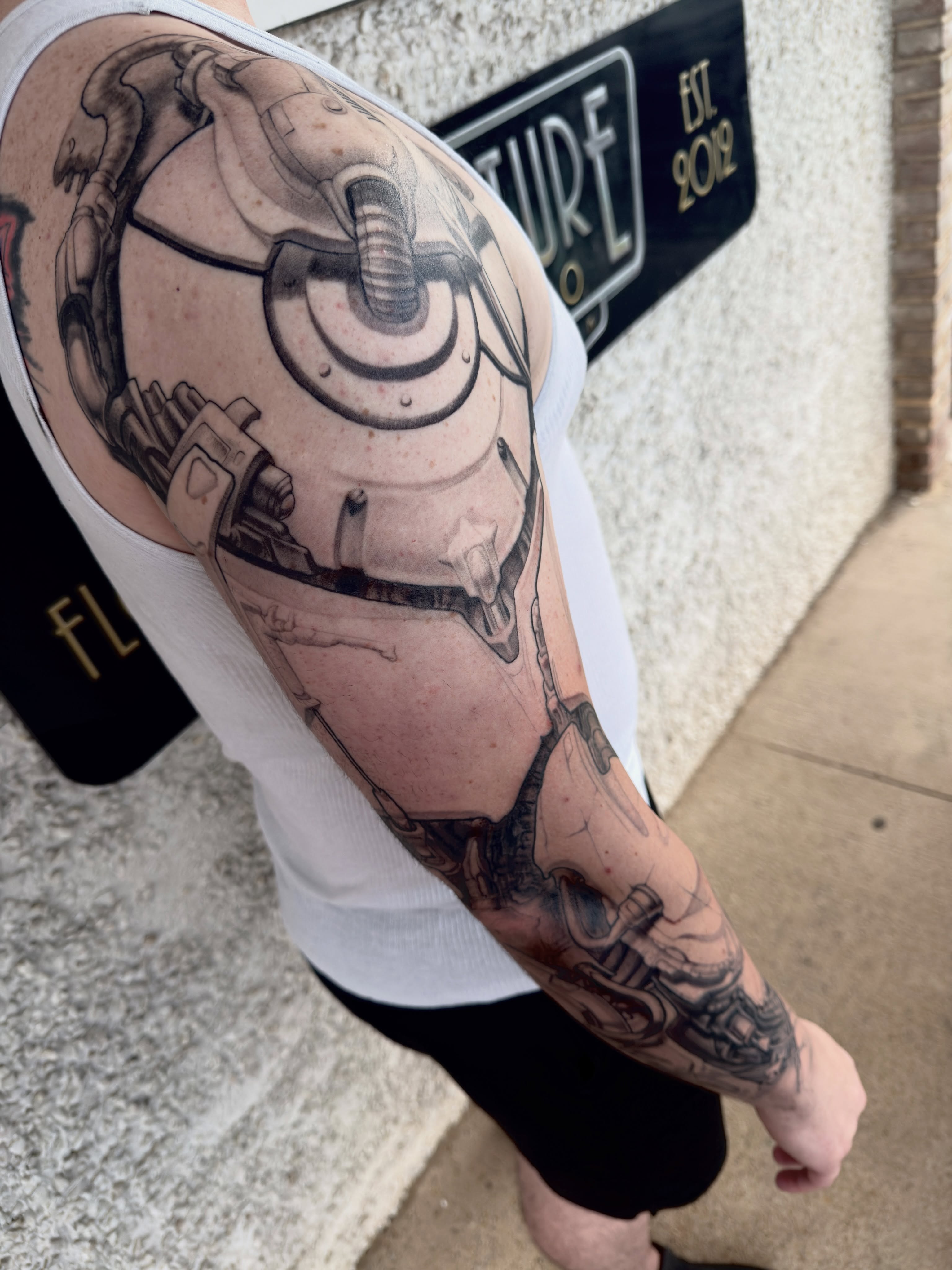 Mechanical sphere geometric tattoo on the forearm by Jake Kirk