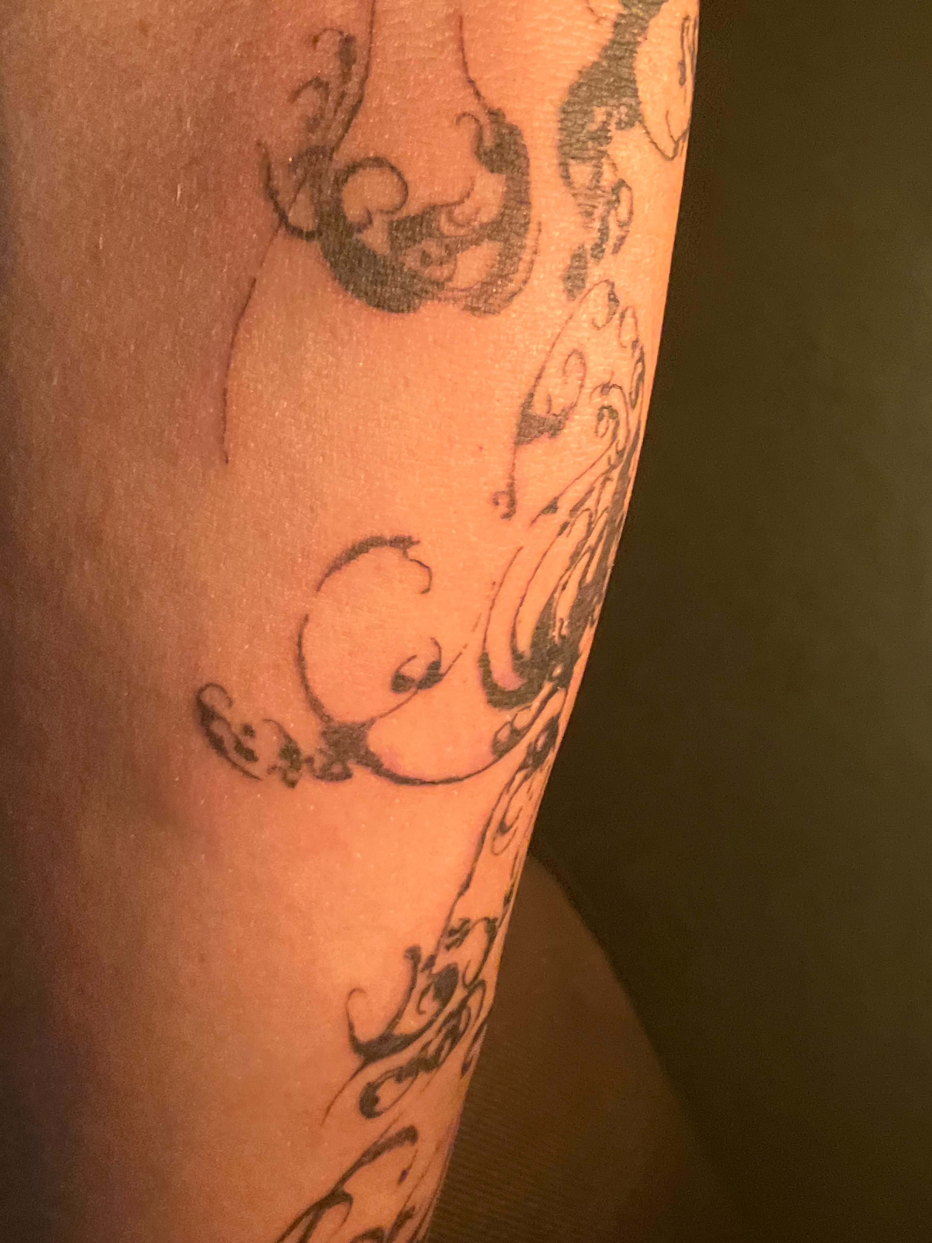 Scrollwork black and grey tattoo on the forearm by Sashka