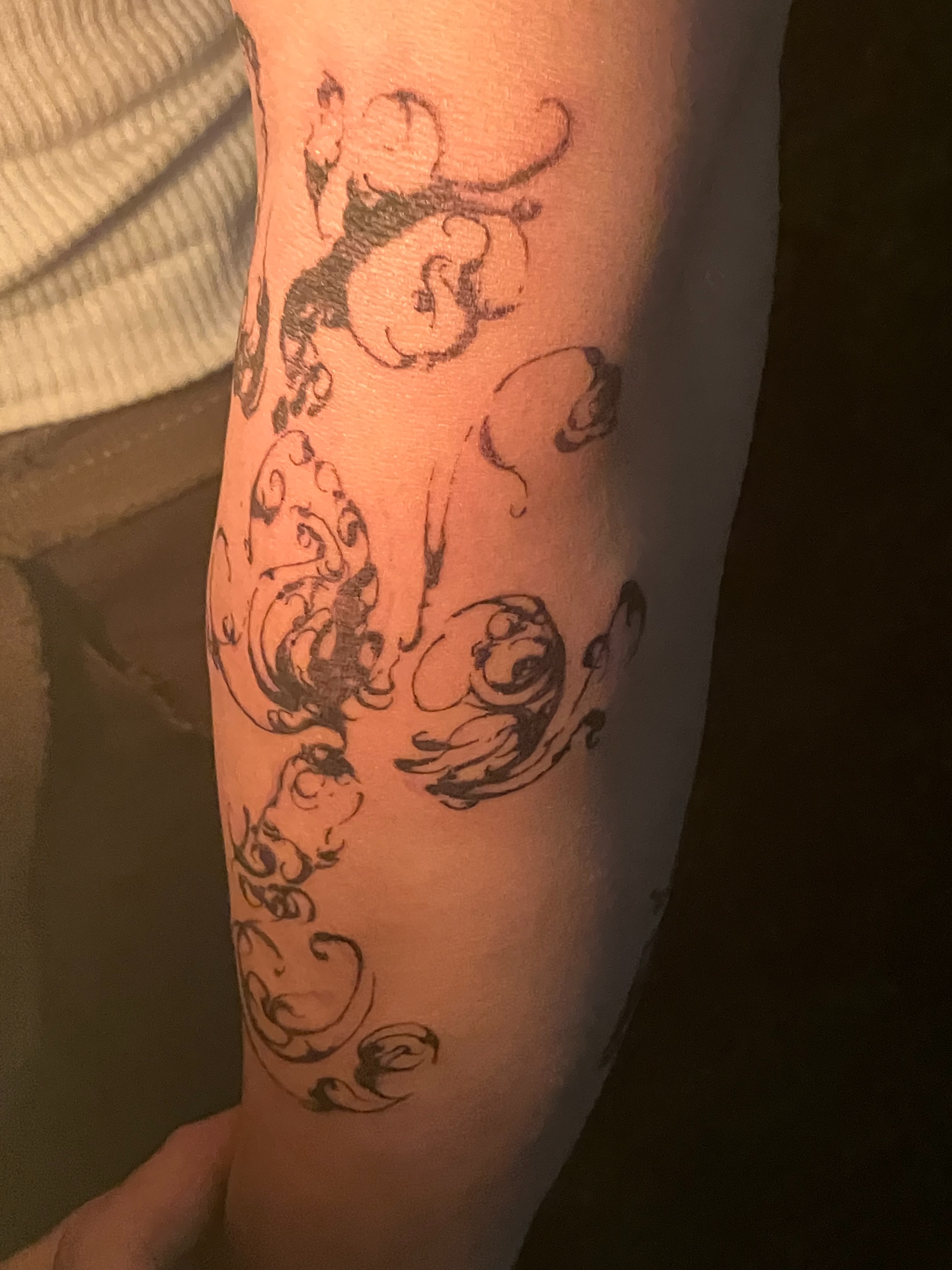 Swirls black and grey tattoo on the forearm by Sashka