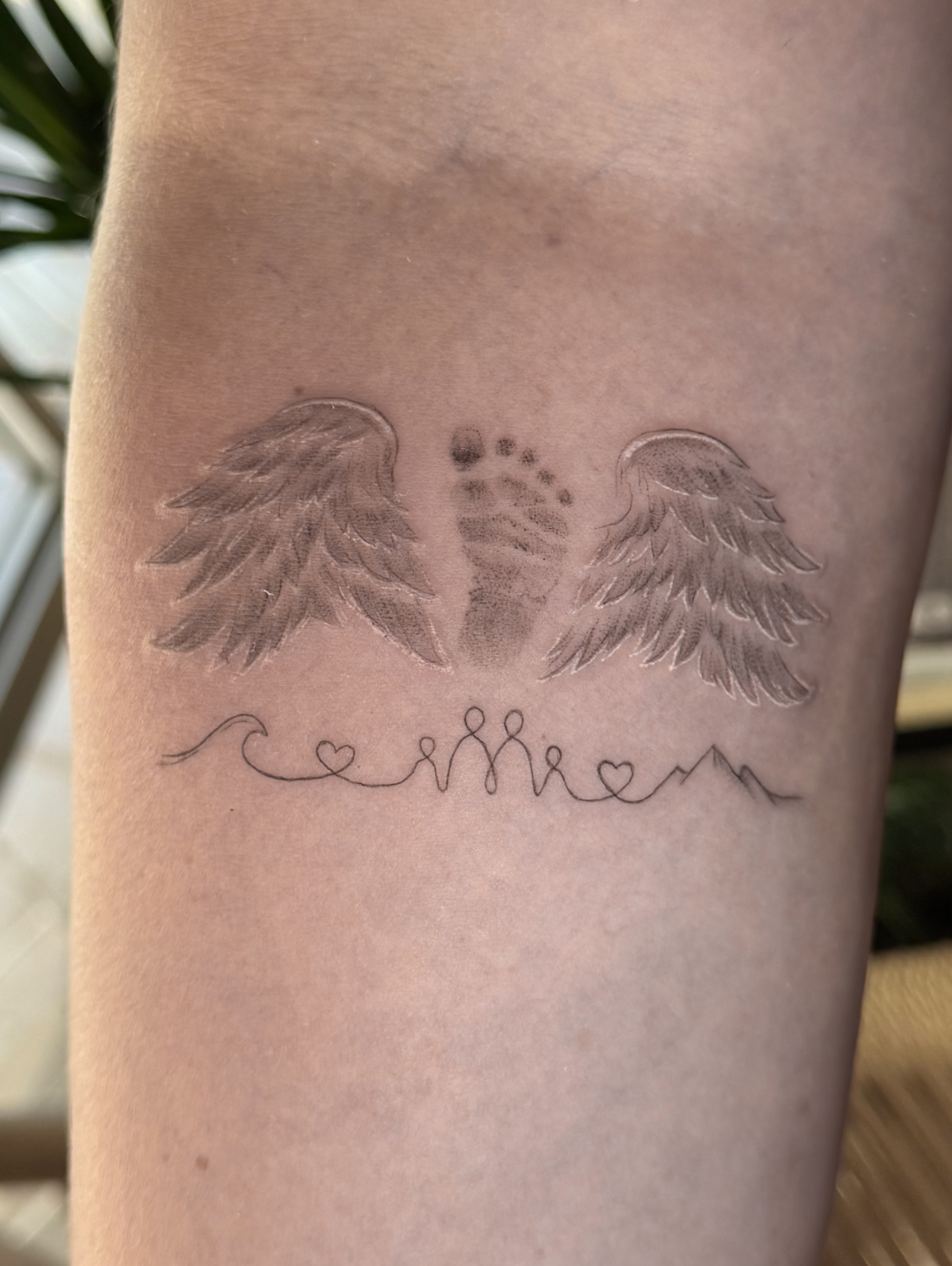 Baby footprint with wings dotwork tattoo on the forearm by fine line tattoo artist▪️Austin TX