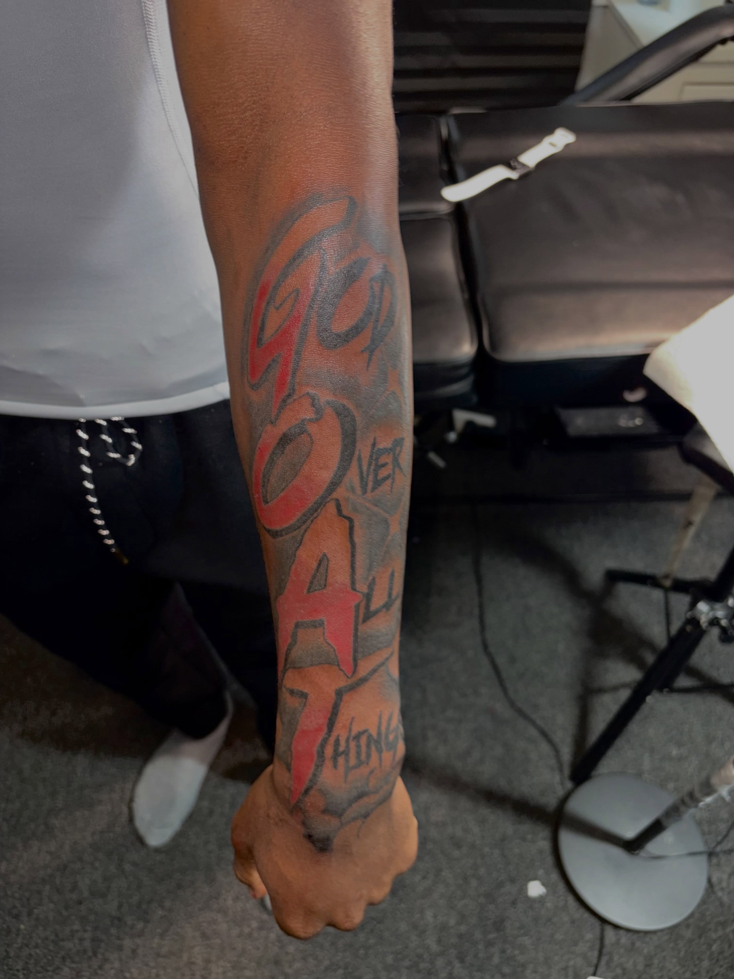 Over all things lettering script tattoo on the forearm by 216 Tattoos 🥰