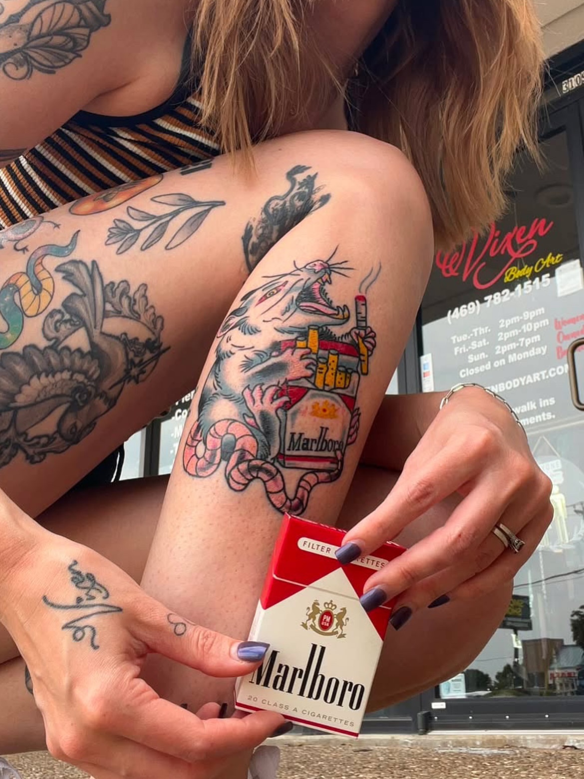 Lion and cigarette American traditional tattoo on the forearm by Hayley Hendrick