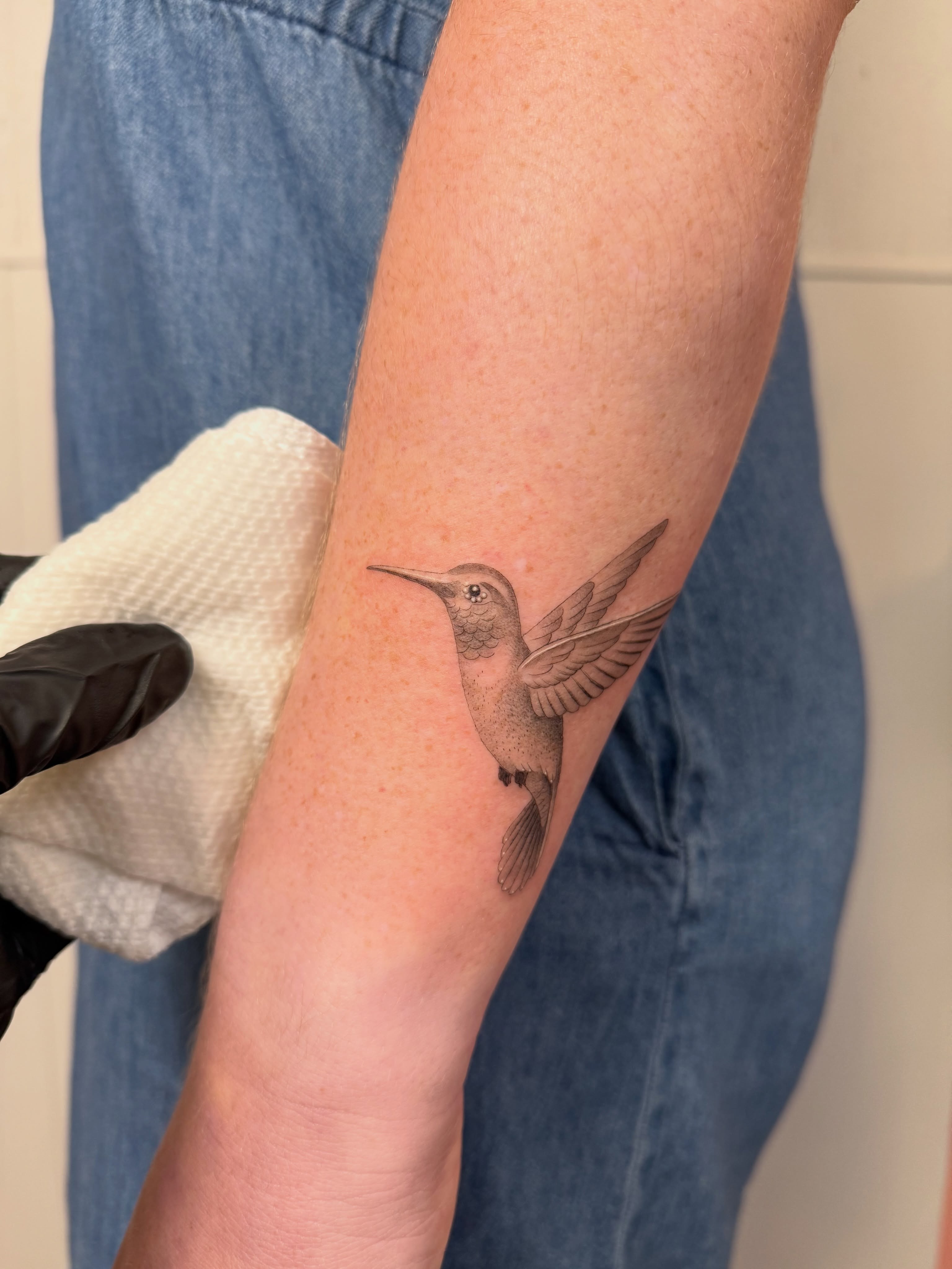 Hummingbird realism tattoo on the forearm by Justin Turkus