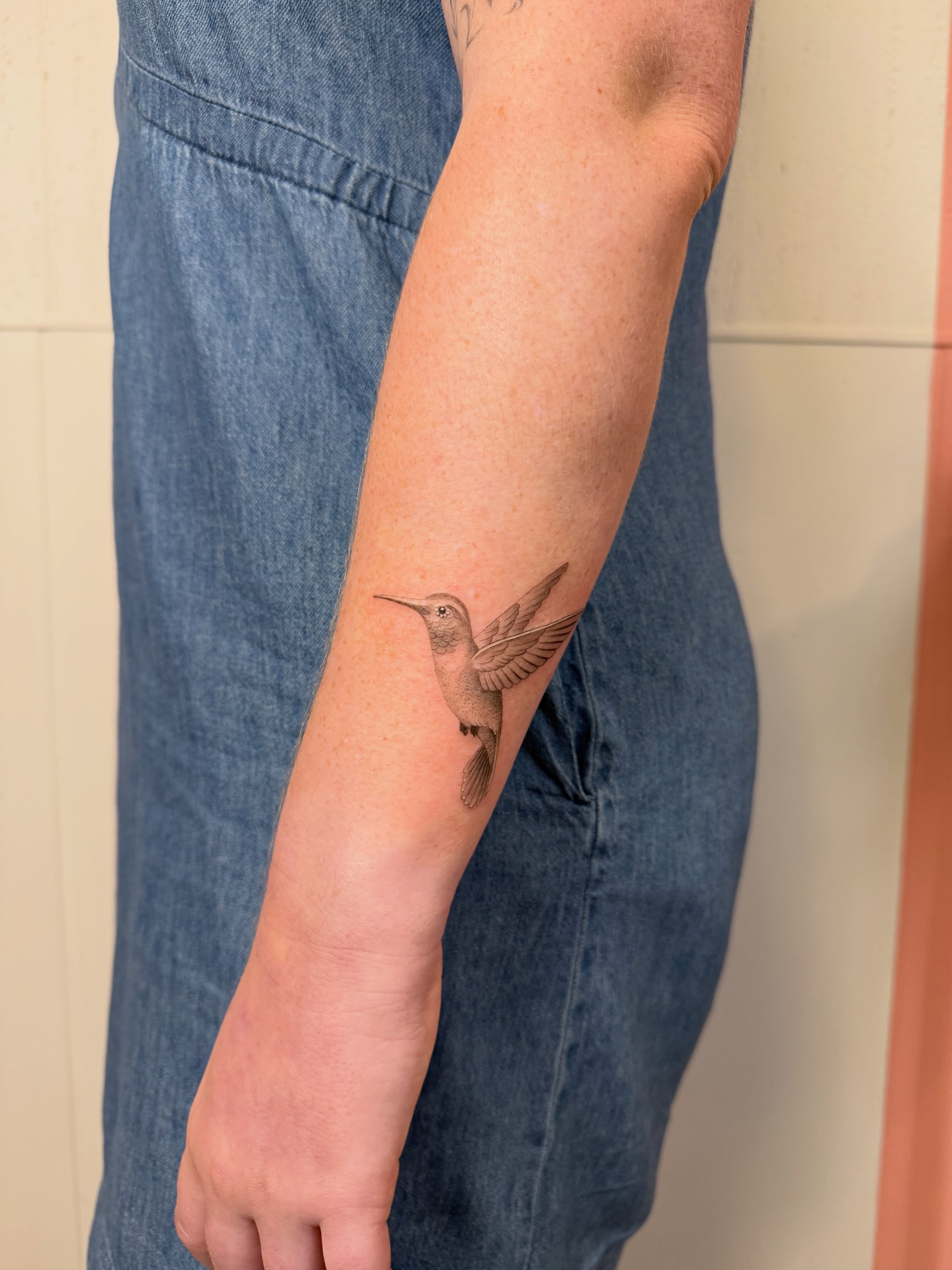 Hummingbird black and grey tattoo on the forearm by Justin Turkus