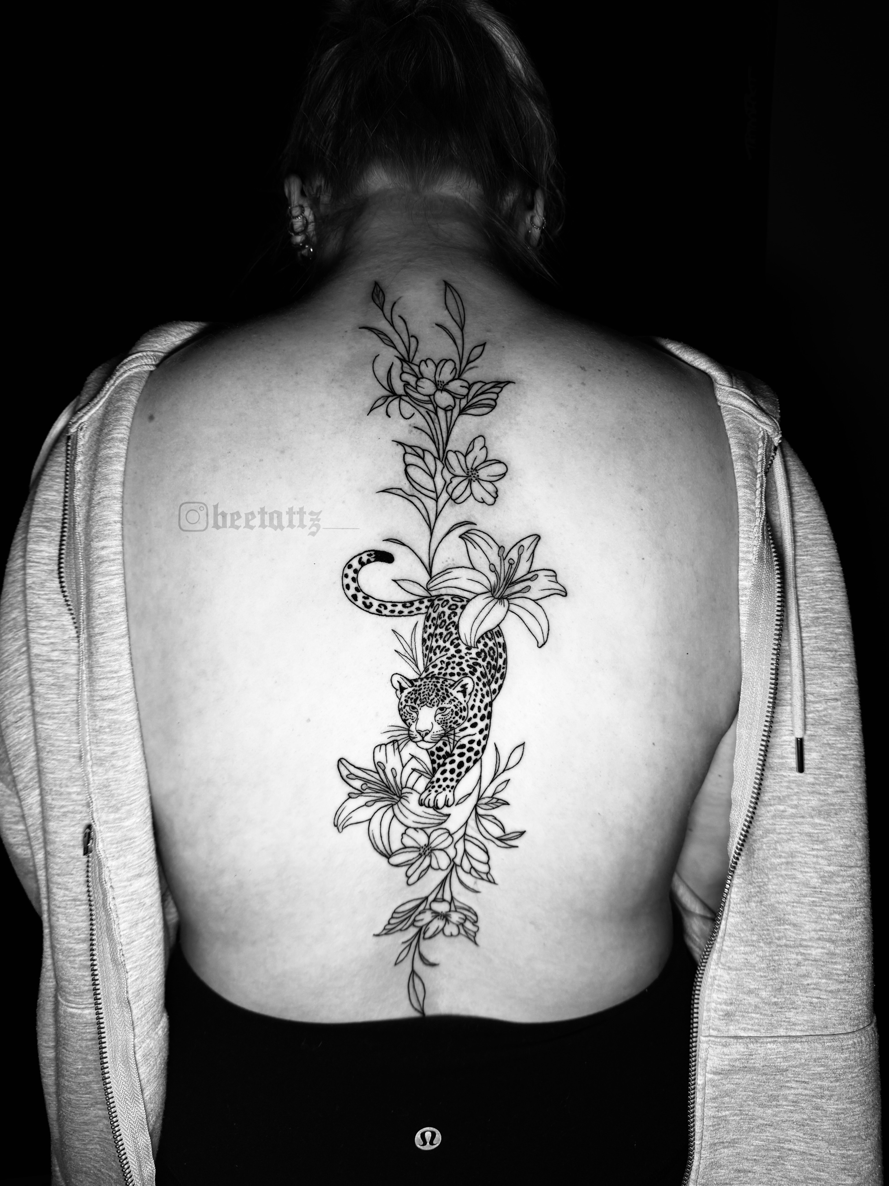 Leopard and flowers realism tattoo on the back by Brinkley McGill