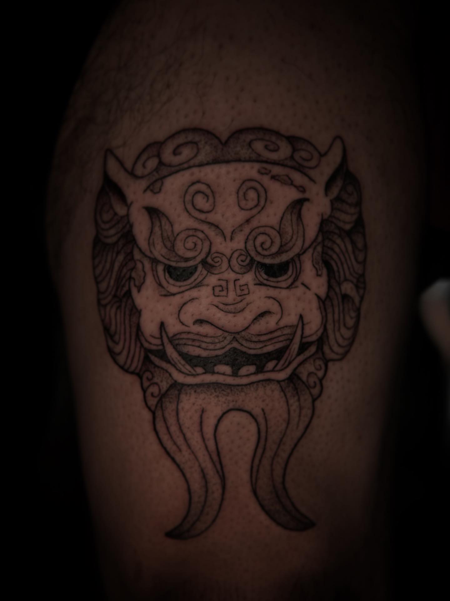 Mask dotwork tattoo on the thigh by Angie Milano