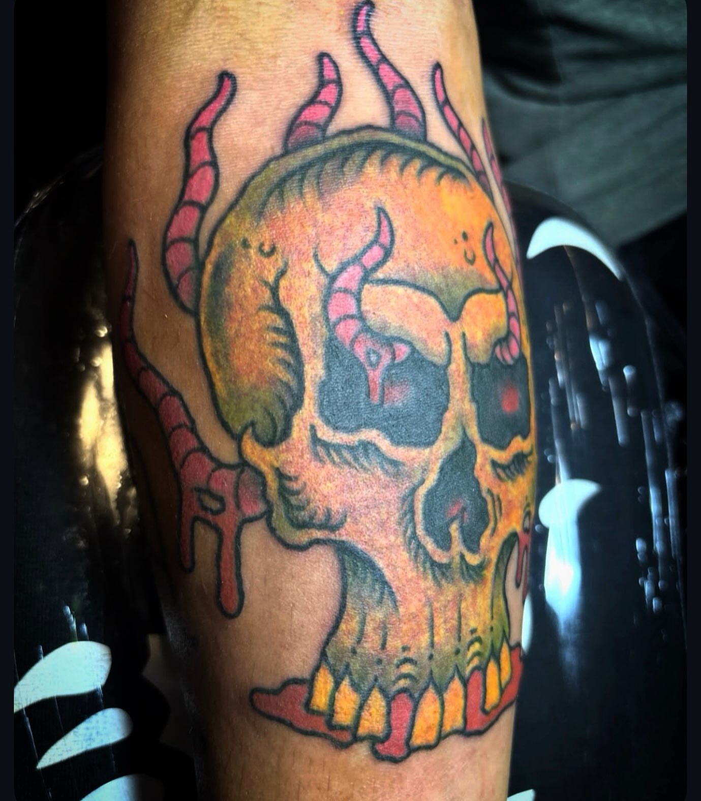 Skull with horns American traditional tattoo on the forearm by Visionary Tattoos