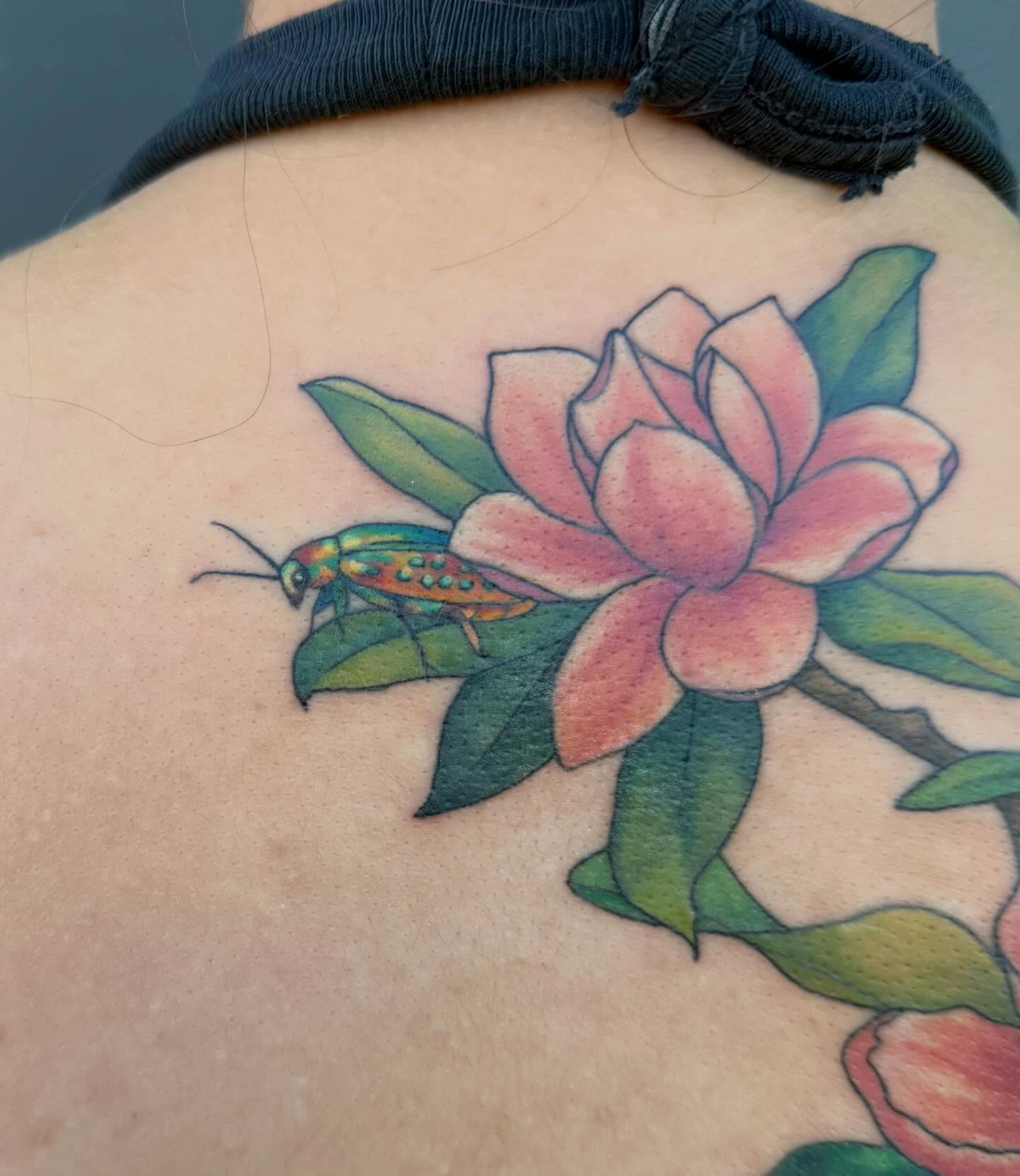 Flower and beetle realism tattoo on the back by Linzi Hungerford, Bozeman, Montana