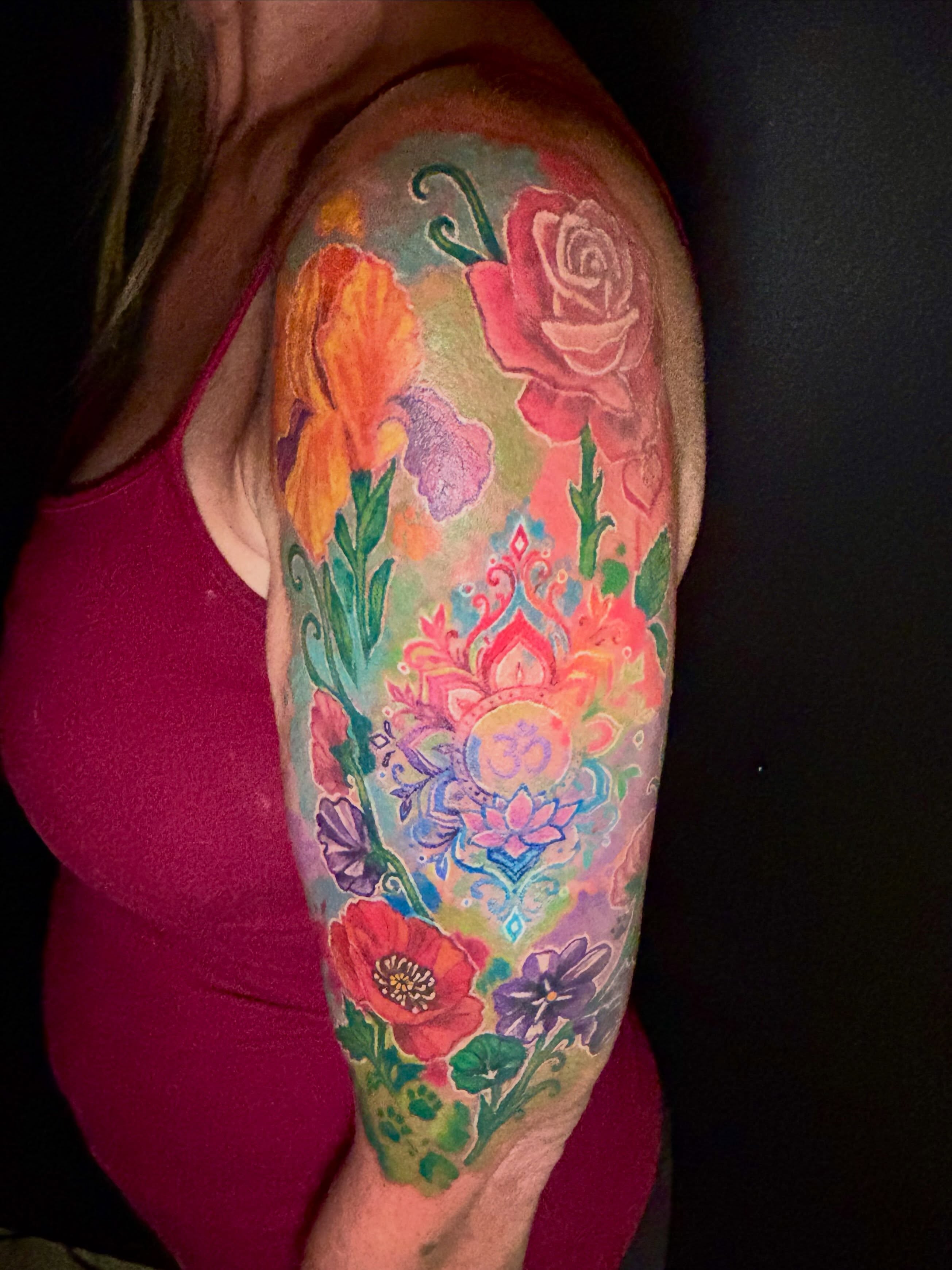Floral bouquet watercolor tattoo on the upper arm by Taylor Tha Color Queen