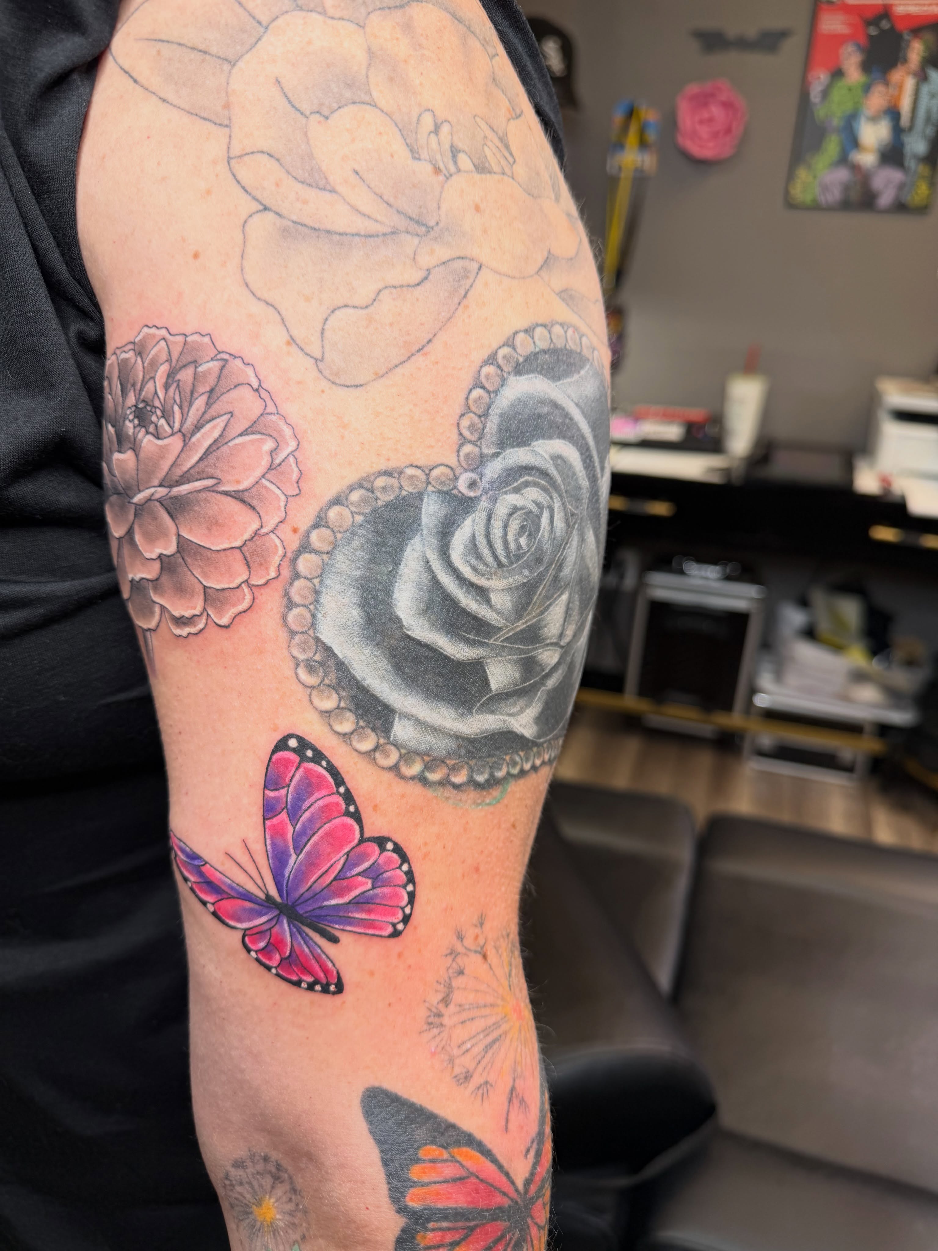 Butterfly and roses realism tattoo on the forearm by Rain David