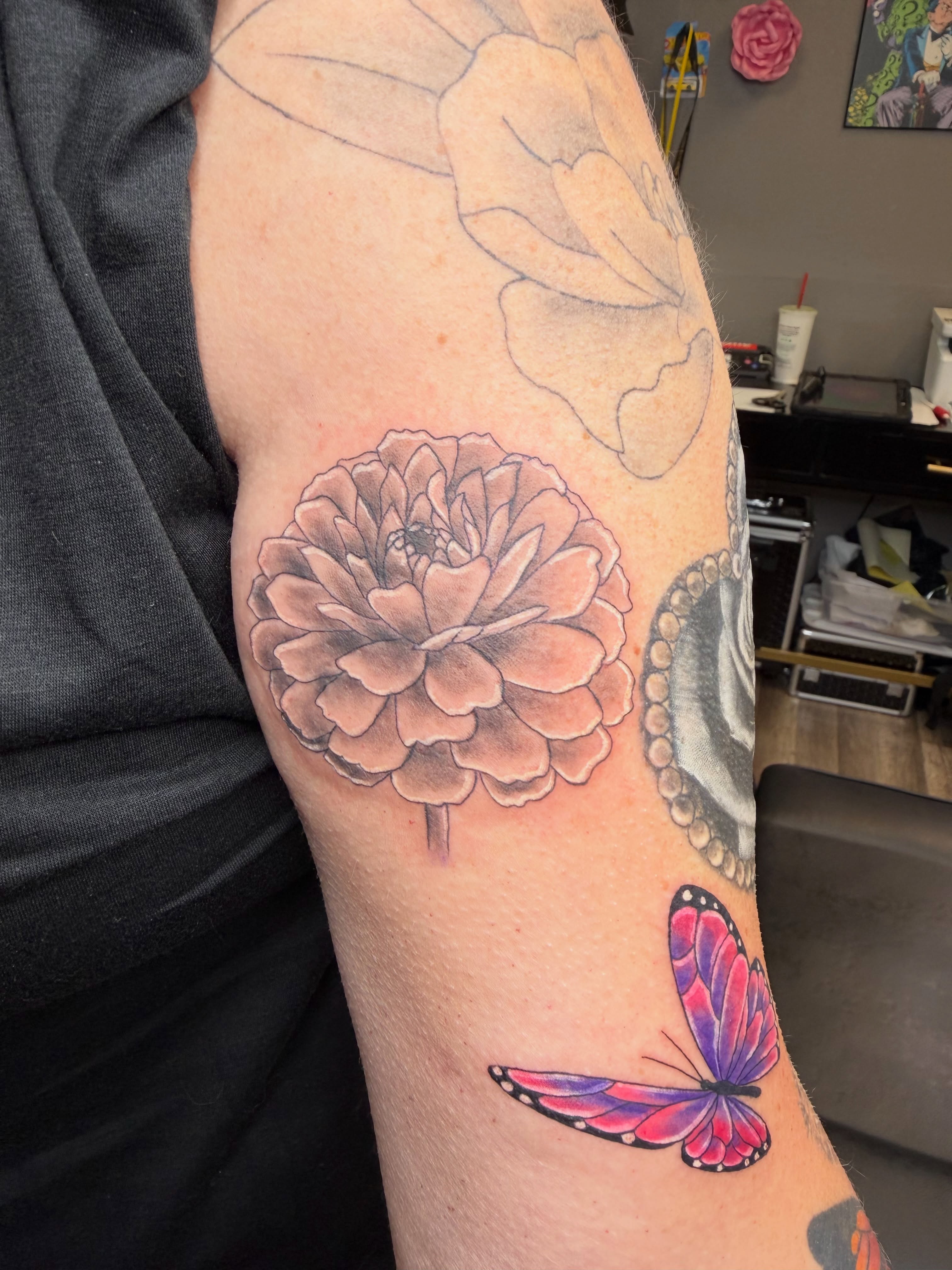 Flower and butterfly realism tattoo on the forearm by Rain David