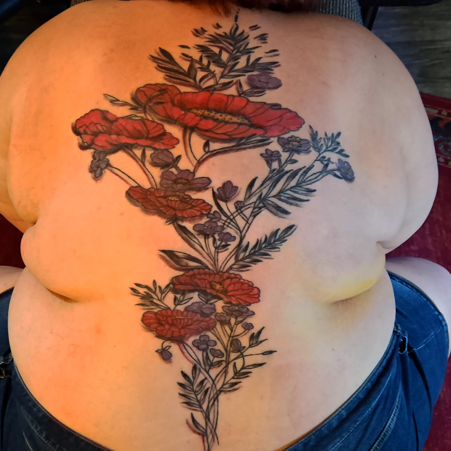 Floral bouquet realism tattoo on the back by Shane Watkins