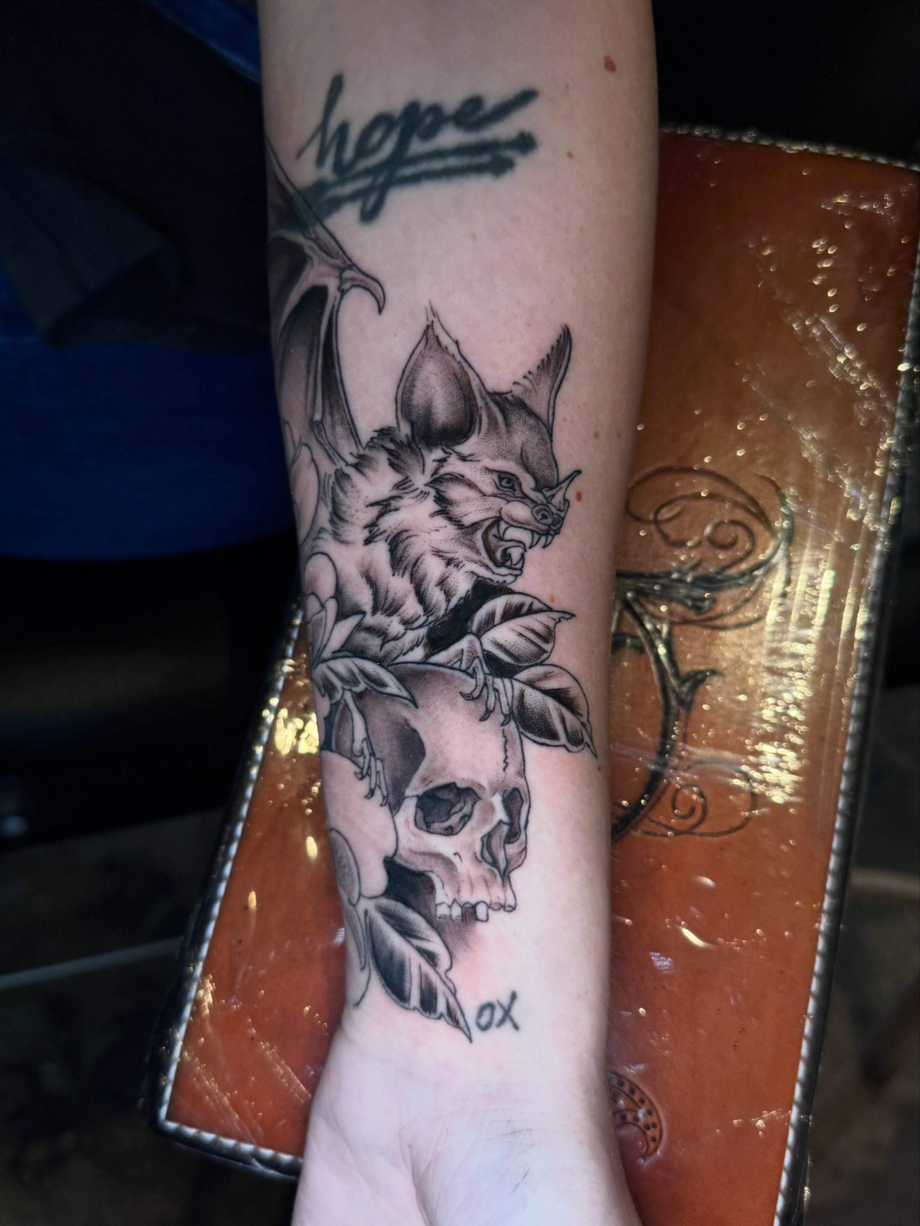 Cat and skull black and grey tattoo on the forearm by Gabrielle Mack
