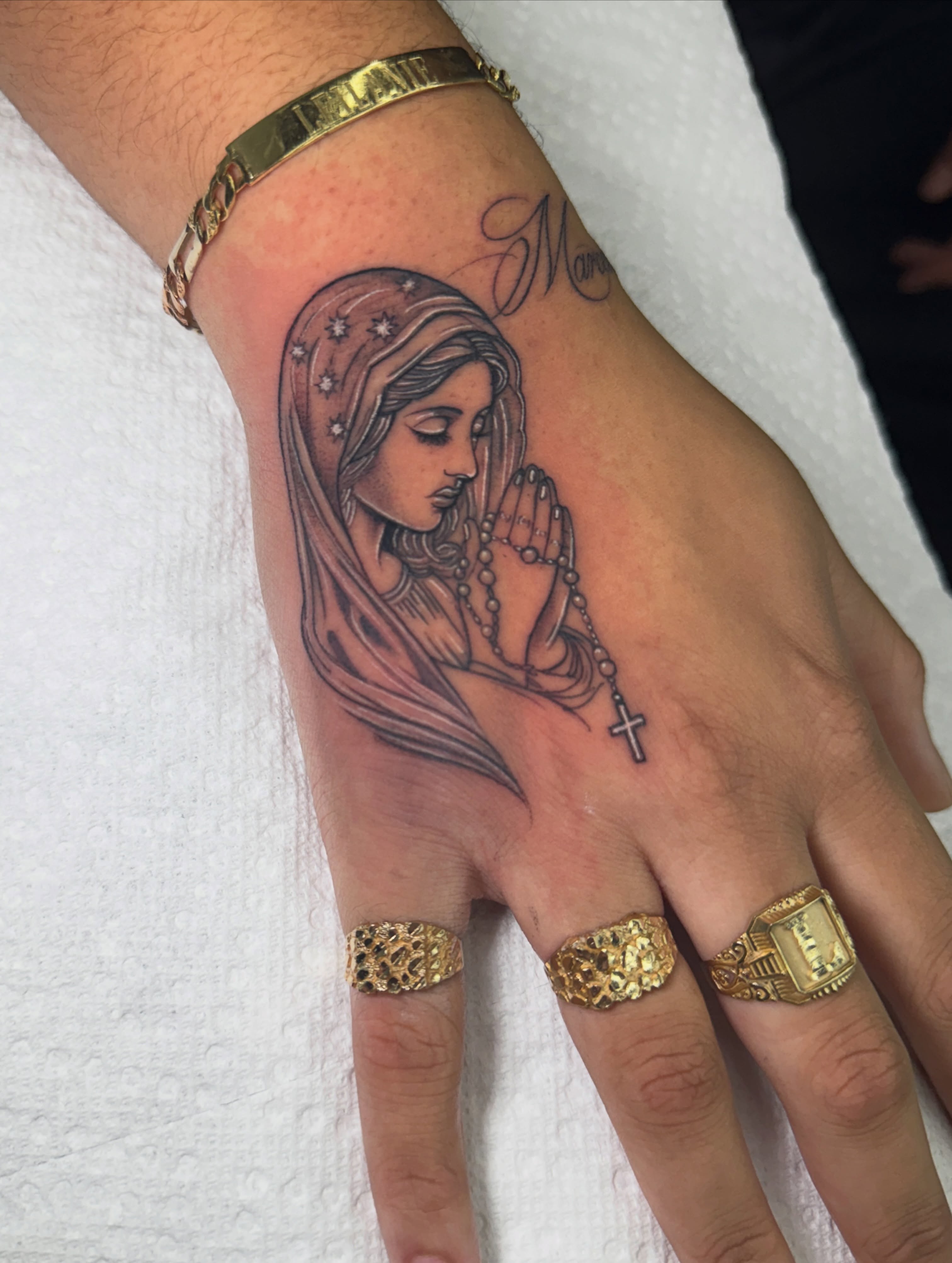 Praying woman realism tattoo on the hand by Eyekonic Ink