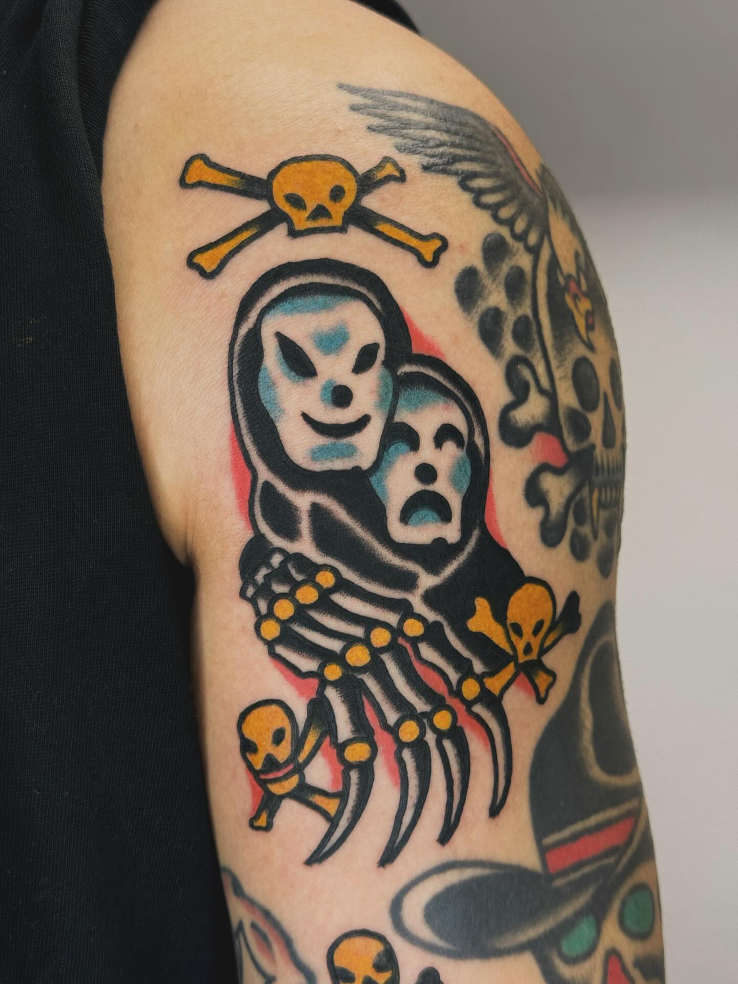 Skeleton couple American traditional tattoo on the upper arm by JAX