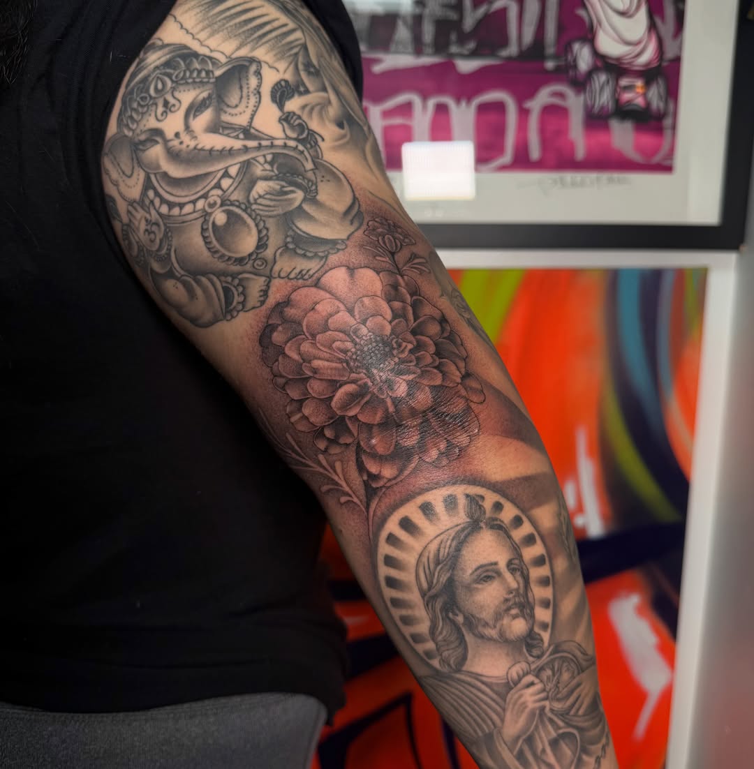 Religious figure with floral elements realism tattoo on the forearm by H e I D I