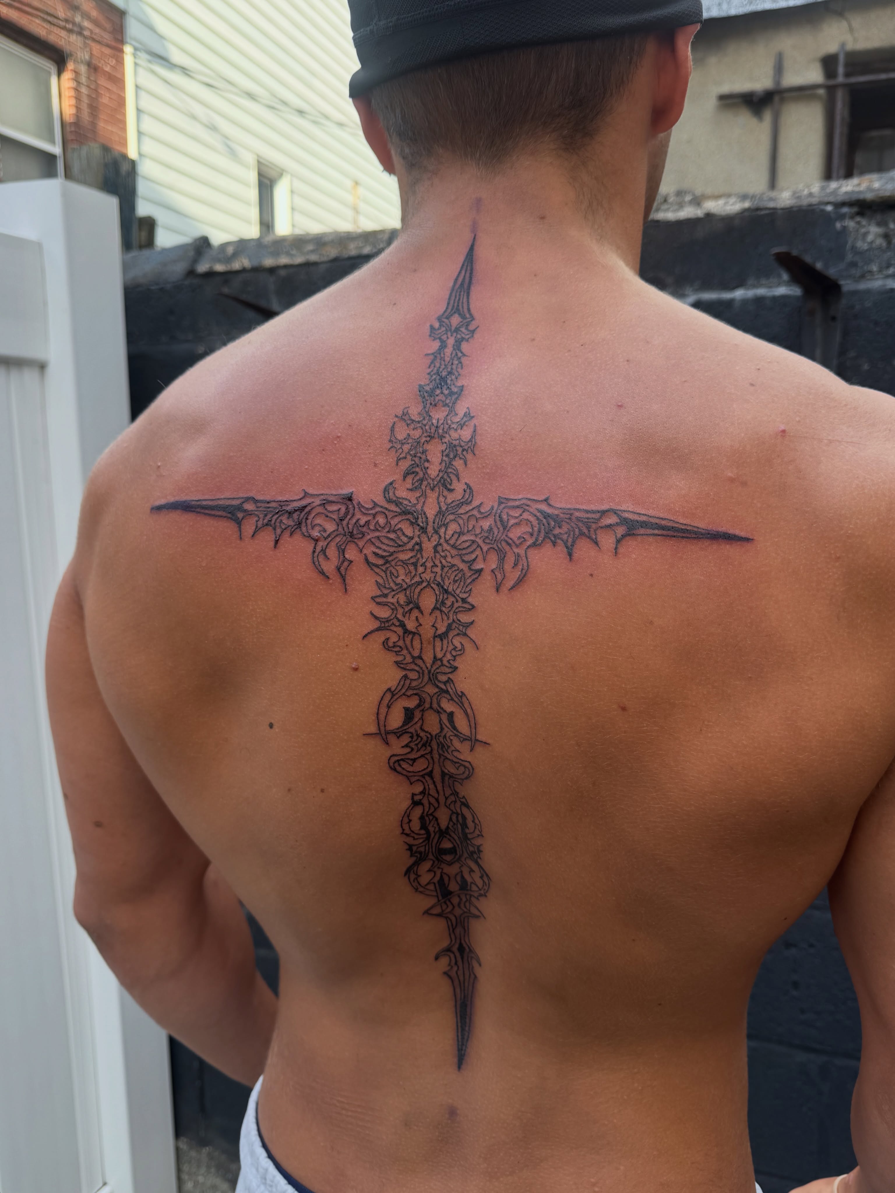 Cross geometric tattoo on the back by dev