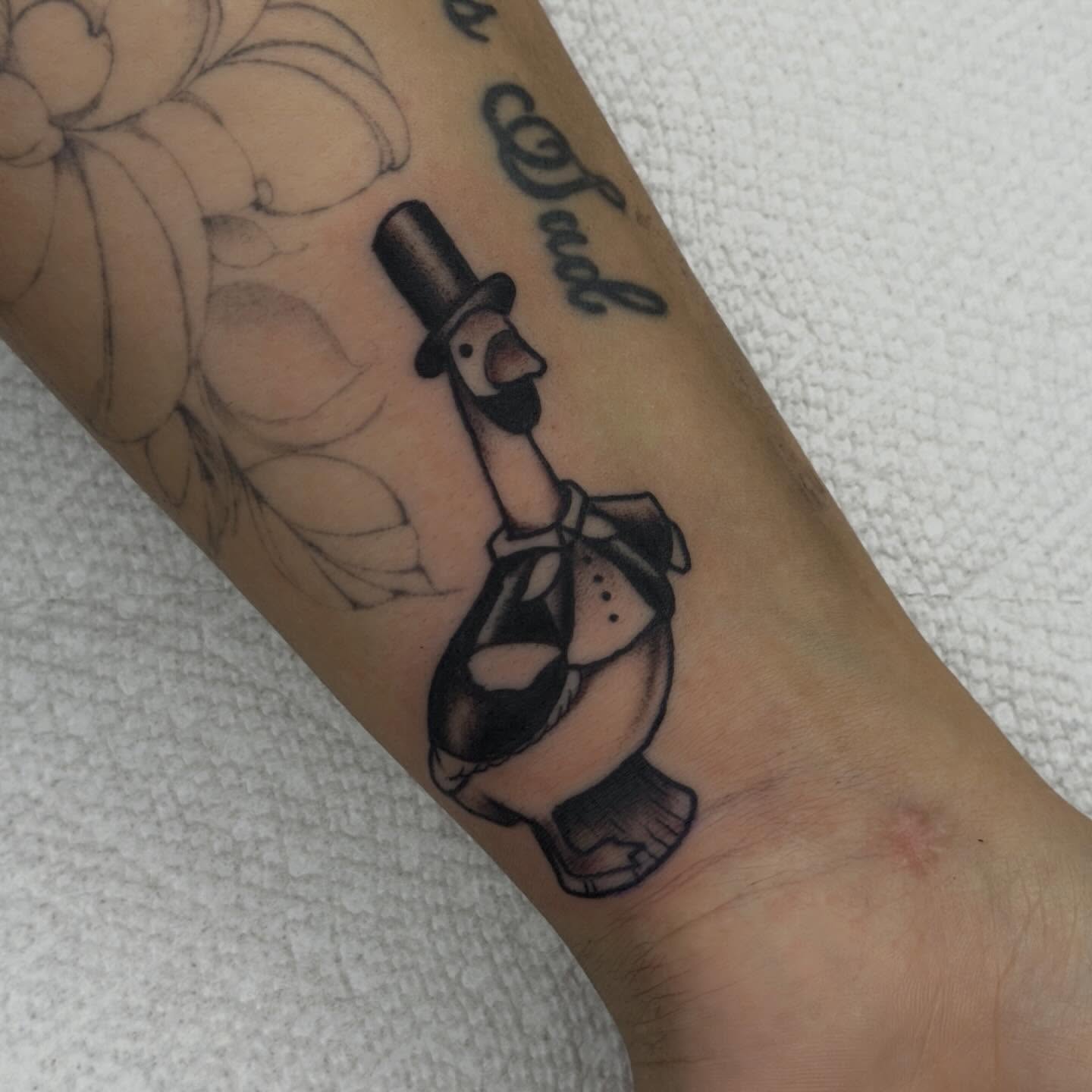 Clown black and grey tattoo on the forearm by Jenna Szerszen-Wynn ๐