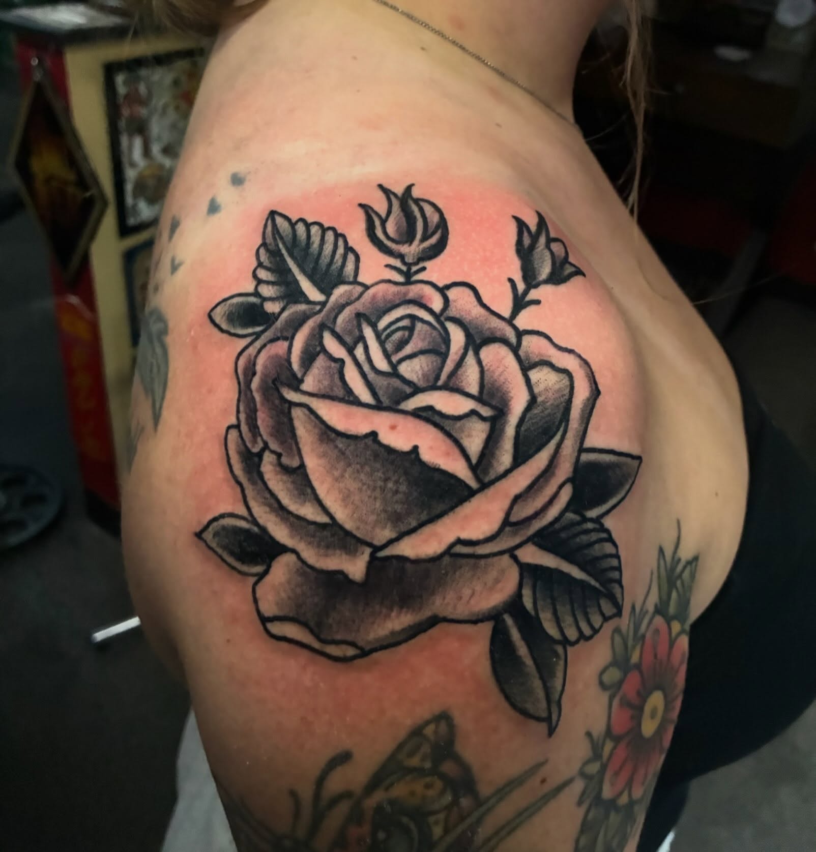Rose American traditional tattoo on the shoulder by Joey Knuckles